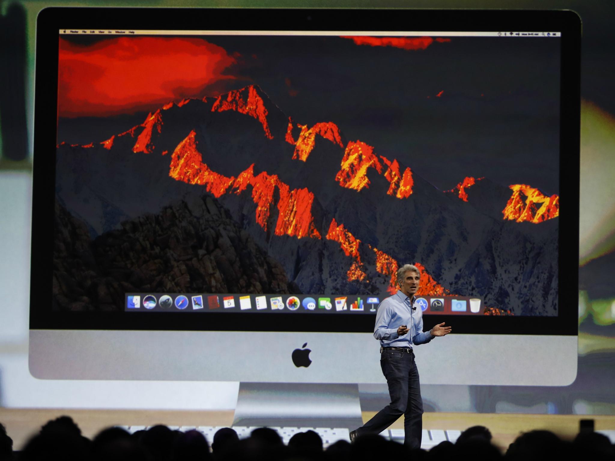 Craig Federighi, Senior Vice President Software Engineering speaks under a projection image of an iMac computer during the company's annual world wide developer conference (WWDC) in San Jose, California, U.S. June 5, 2017