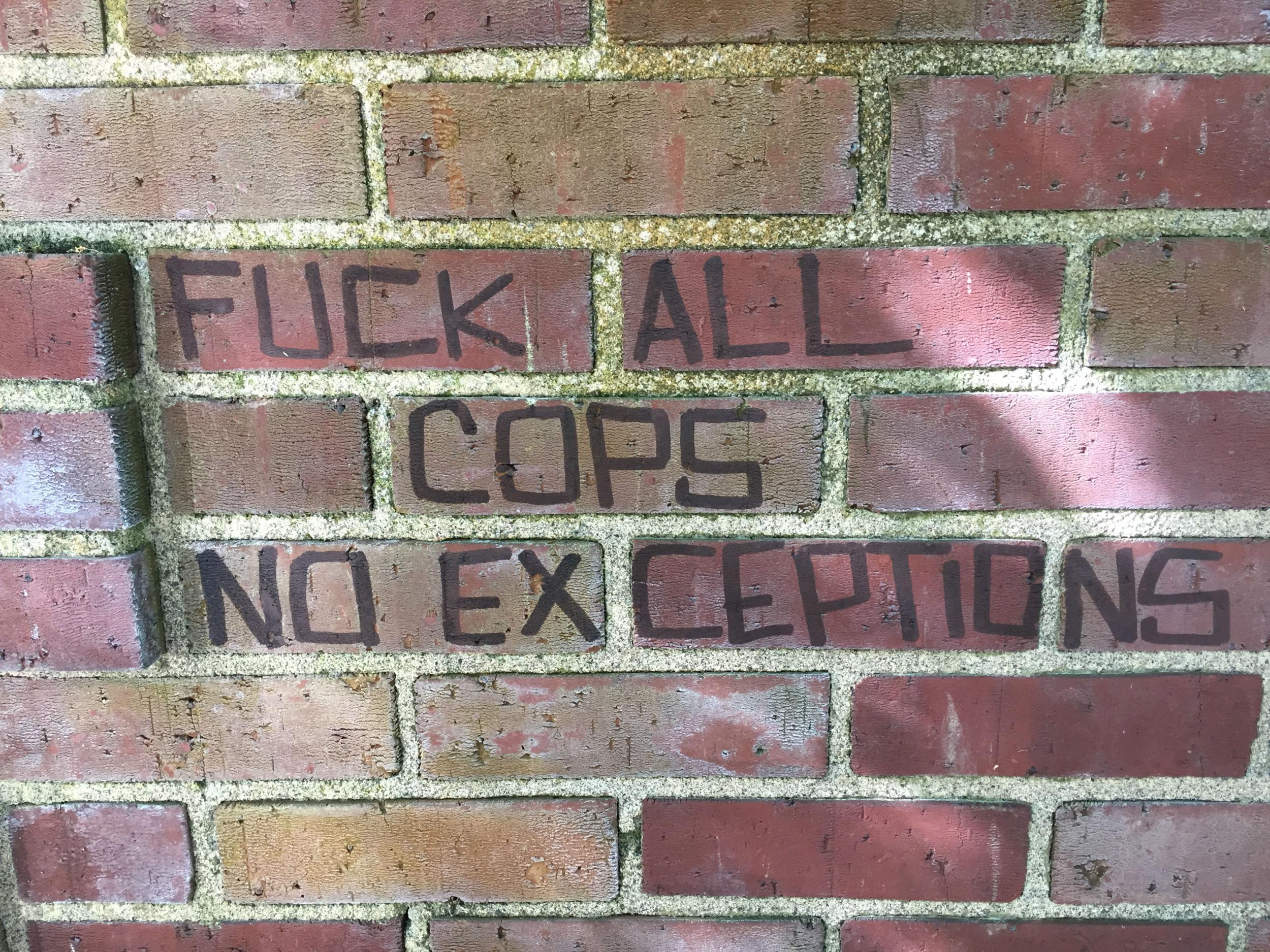 Graffiti left behind by counter-protestors on a public toilet in Portland's Chapman Park