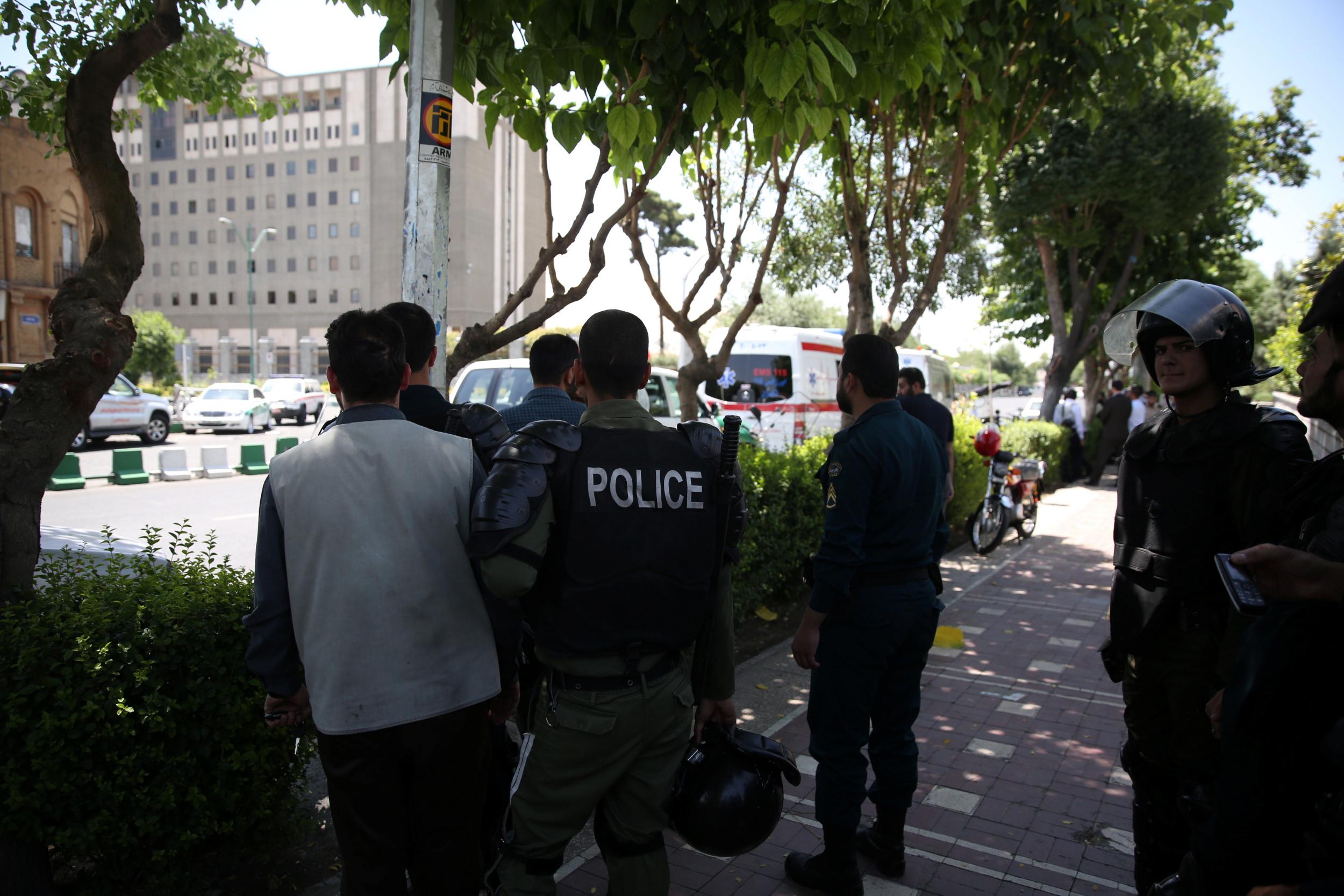 Iranian police stand near parliament during a terror attack in central Tehran, Iran, 7 June 2017 (REUTERS)