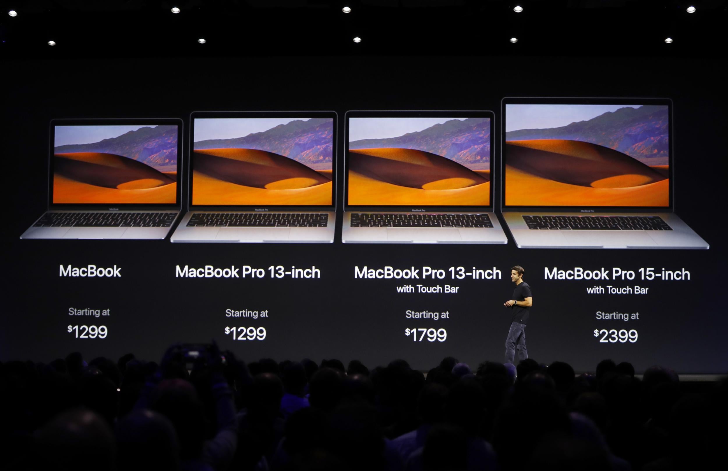 John Ternus, Vice President, Mac and iPad Hardware Engineering speaks under a graphic of price points for the Macbook laptop family during Apple's annual world wide developer conference (WWDC) in San Jose, California, U.S. June 5, 2017