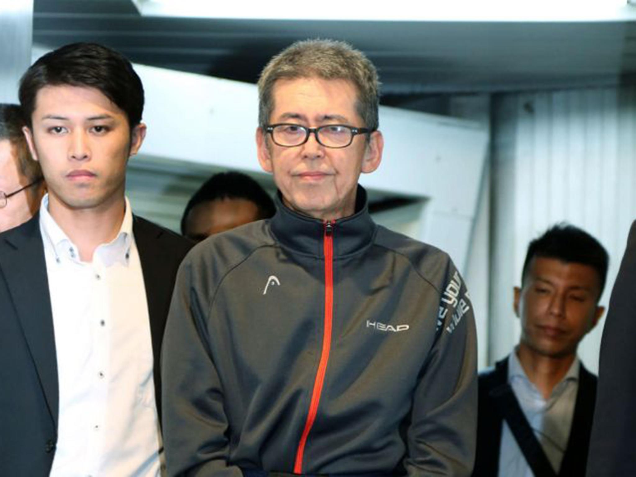 Masaaki Osaka (C), once a high-ranking member of the Japan Revolutionary Communist League, arrives at Tokyo's Haneda airport