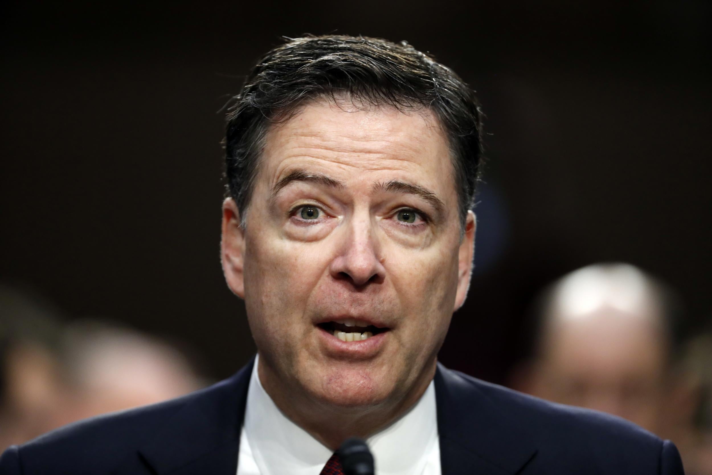 Former FBI Director James Comey speaks during a Senate Intelligence Committee hearing on Capitol Hill