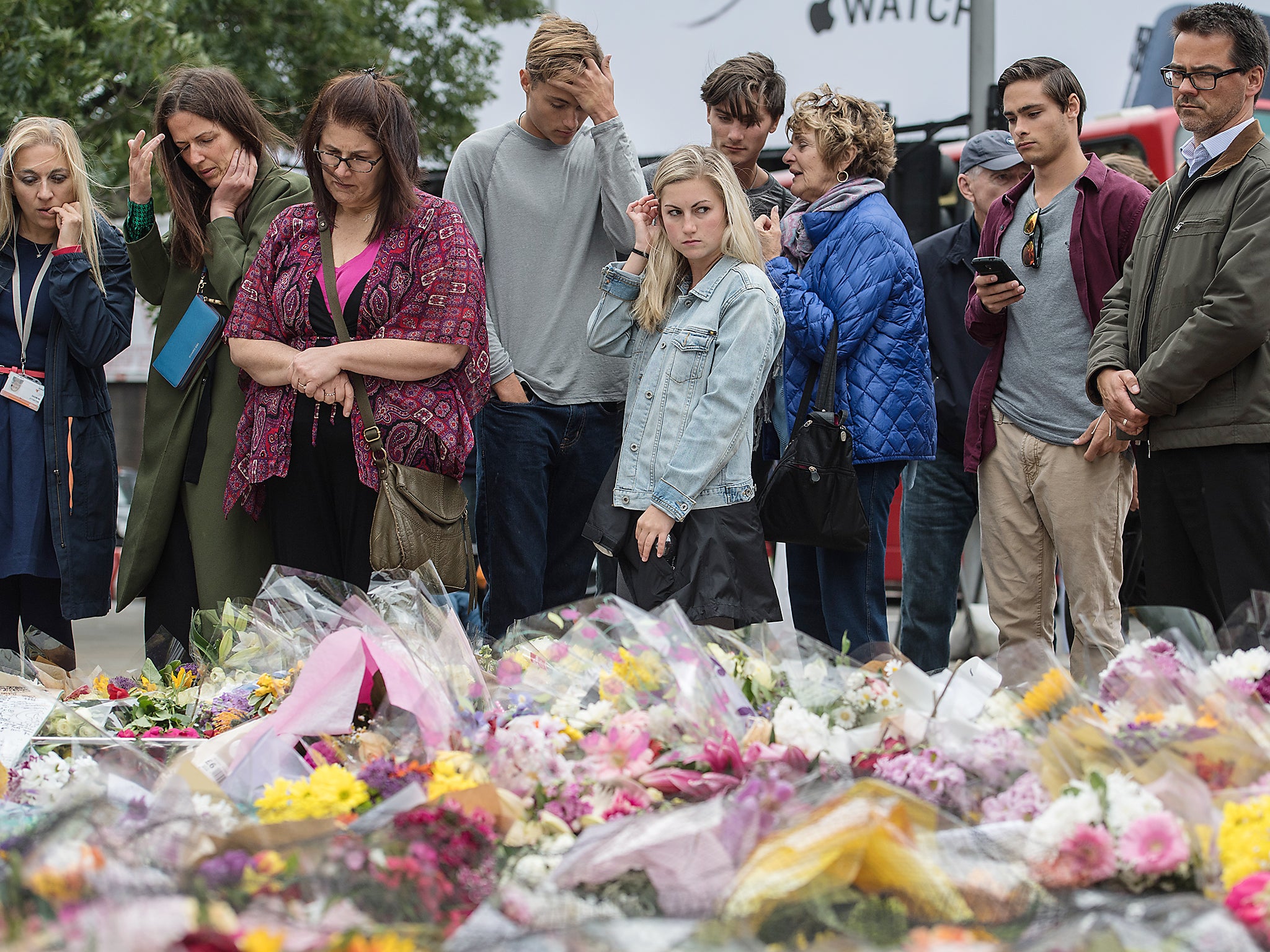 People view flowers and tributes near the scene of the London Bridge attacks