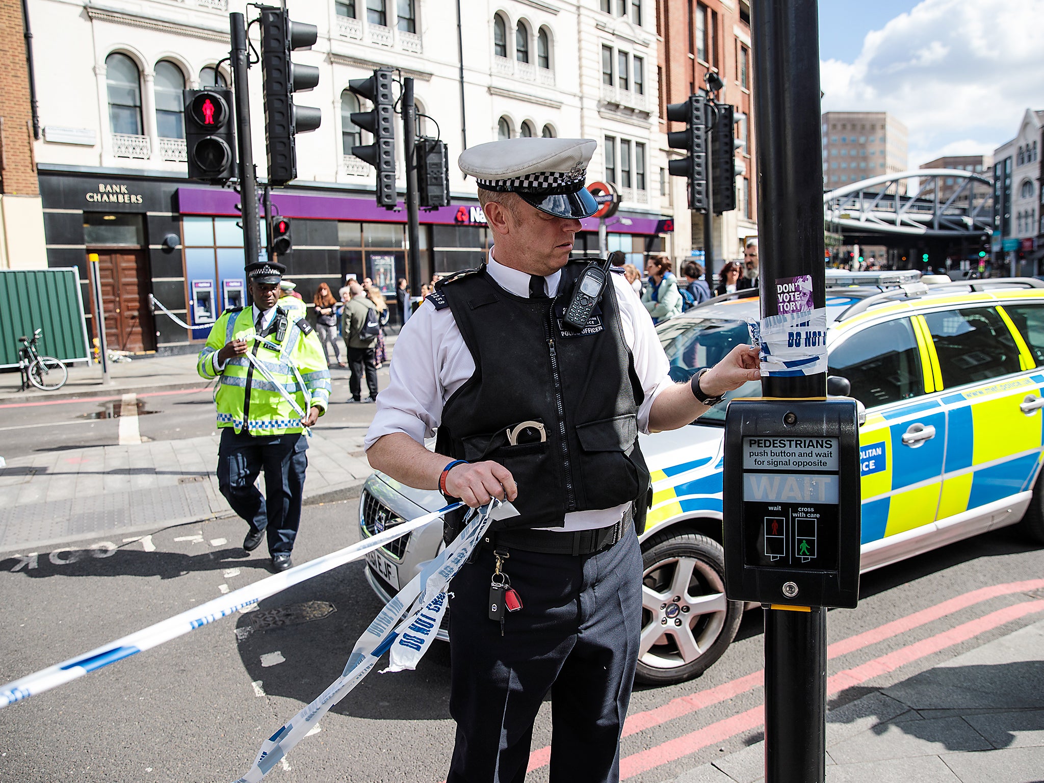 Police officers remove the cordon tape by Borough Market following the June 3rd attacks in London (Getty)