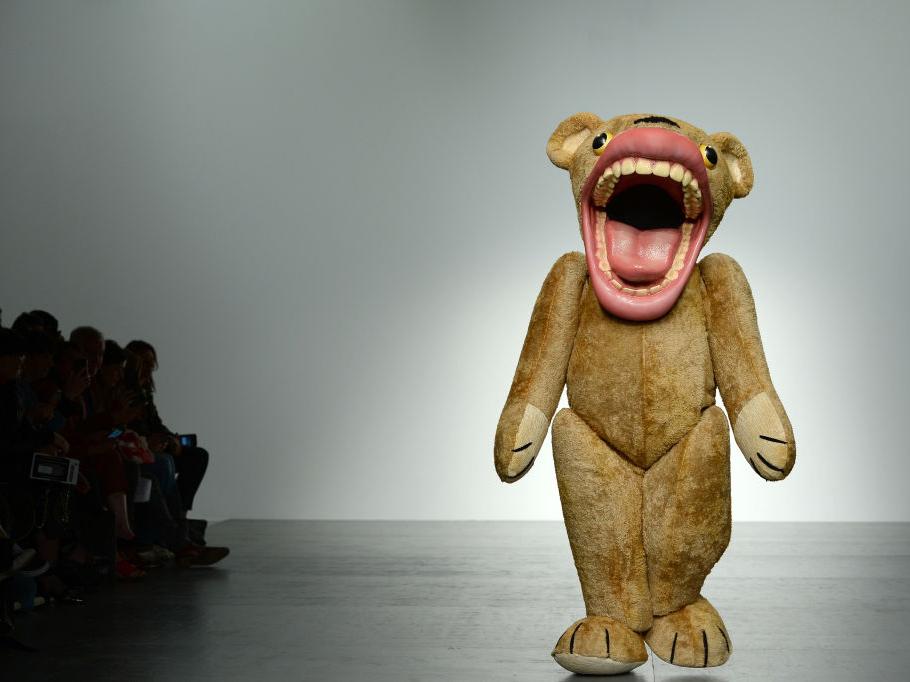 A model in a bear costume walks the runway at the Liam Hodges show