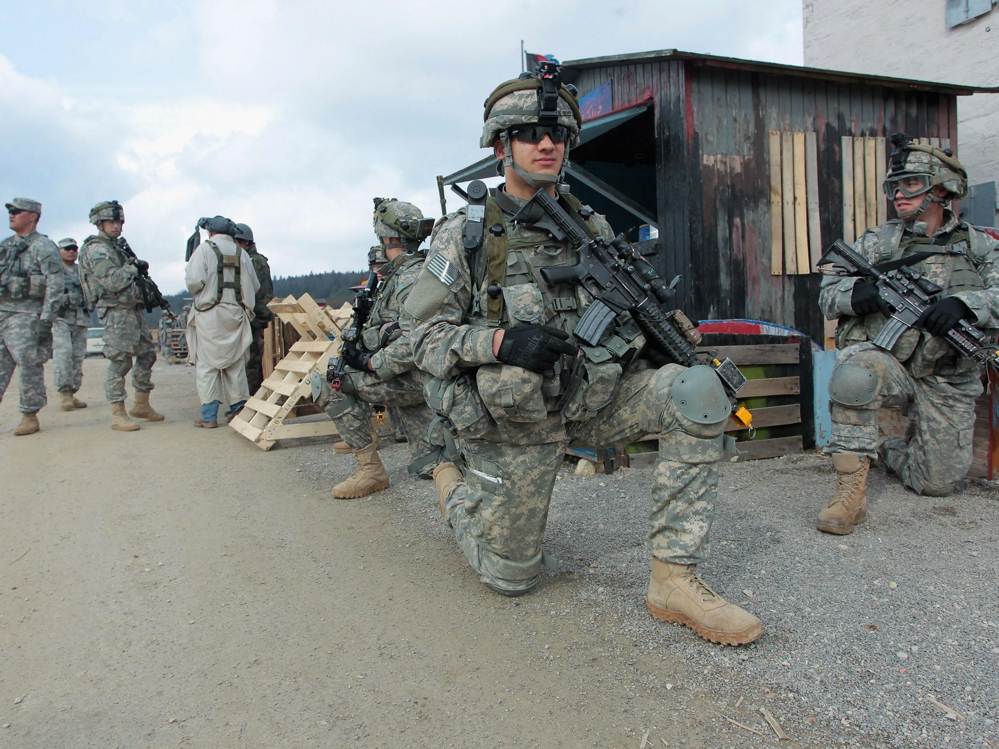 US soldiers of the 173rd Airborne Brigade based in Vicenza, Italy, conduct a patrol through a mock Afghan village during a training exercise at the US Army's Joint Multinational Readiness Center