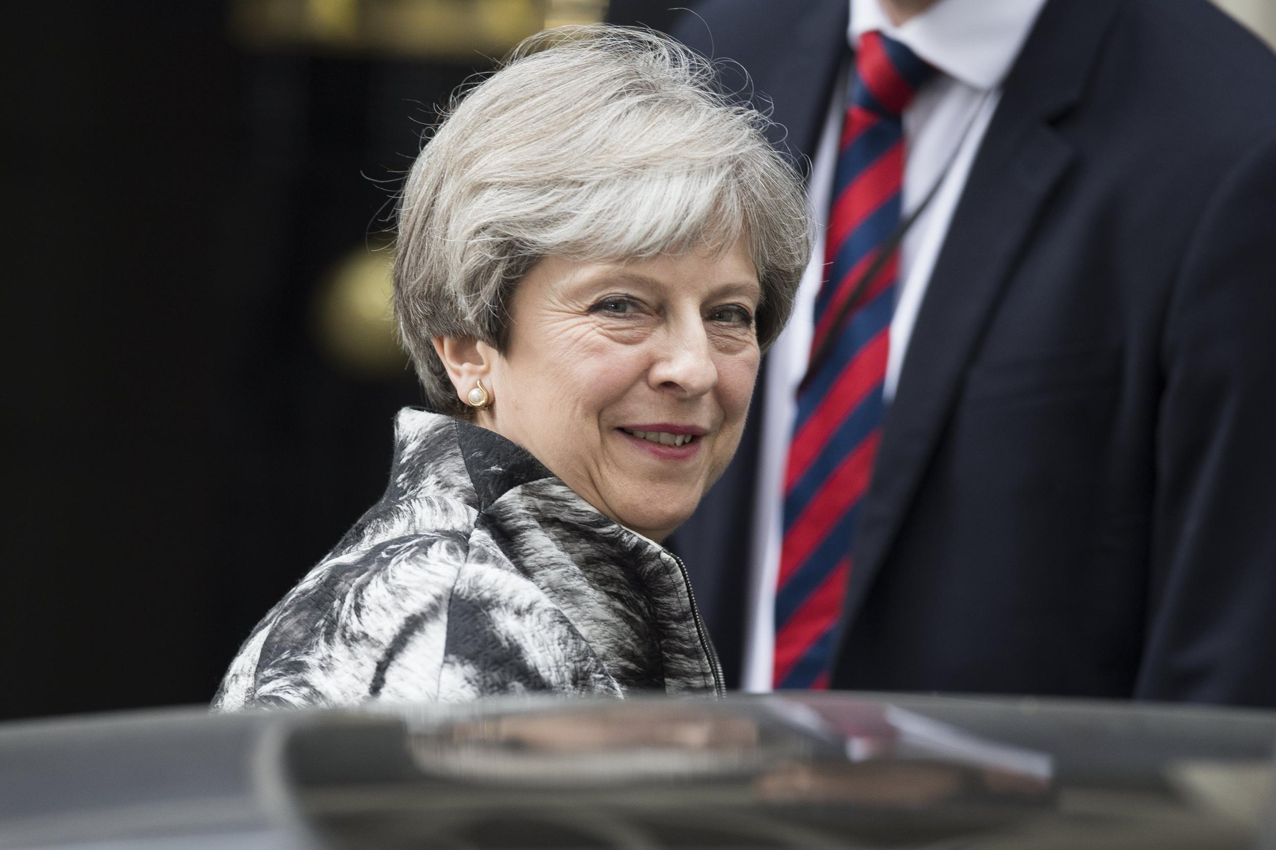 Theresa May leaves Downing Street on the way to a meeting of the Conservative Party's 1922 Committee