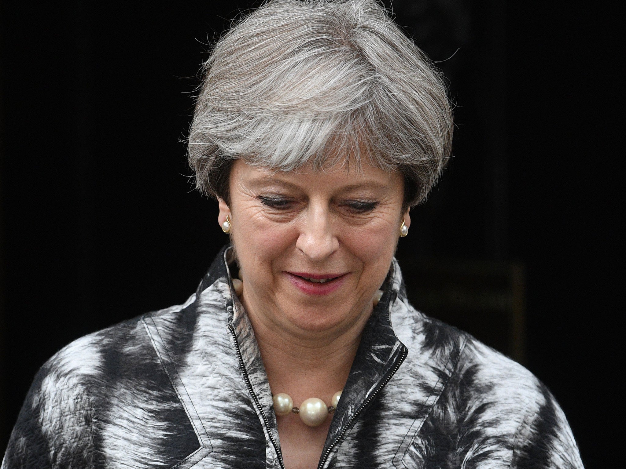 Theresa May leaves Downing Street on the way to a meeting of the Conservative Party's 1922 Committee