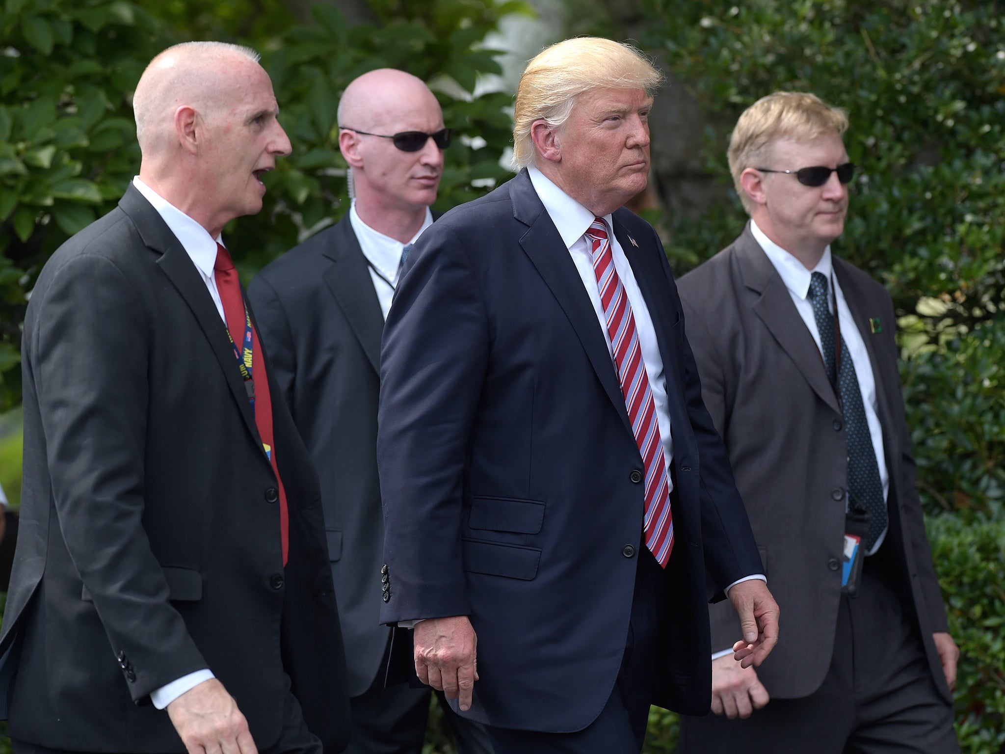 President Trump pictured with his bodyguard and Secret Service agents