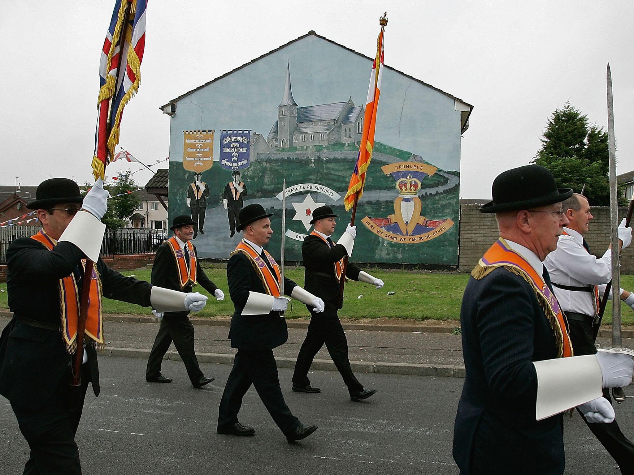 Protestant Orange Order members parade through the Shankhill area of Belfast City, Northern Ireland