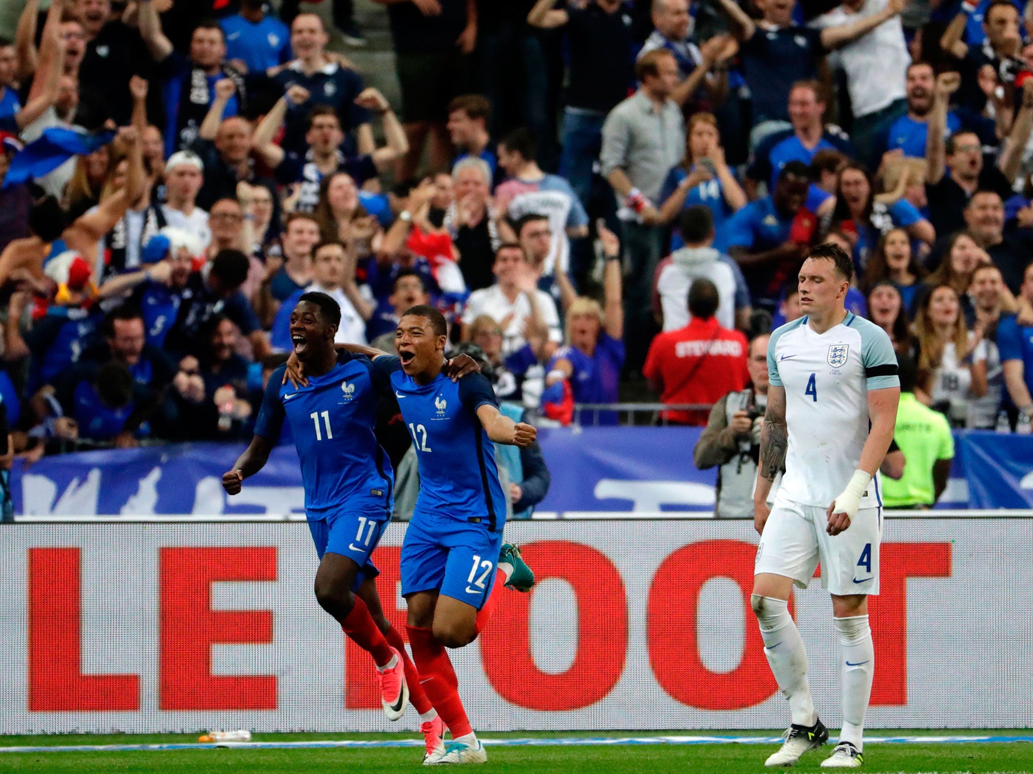 Ousmane Dembele celebrates with Kylian Mbappe after scoring France's third