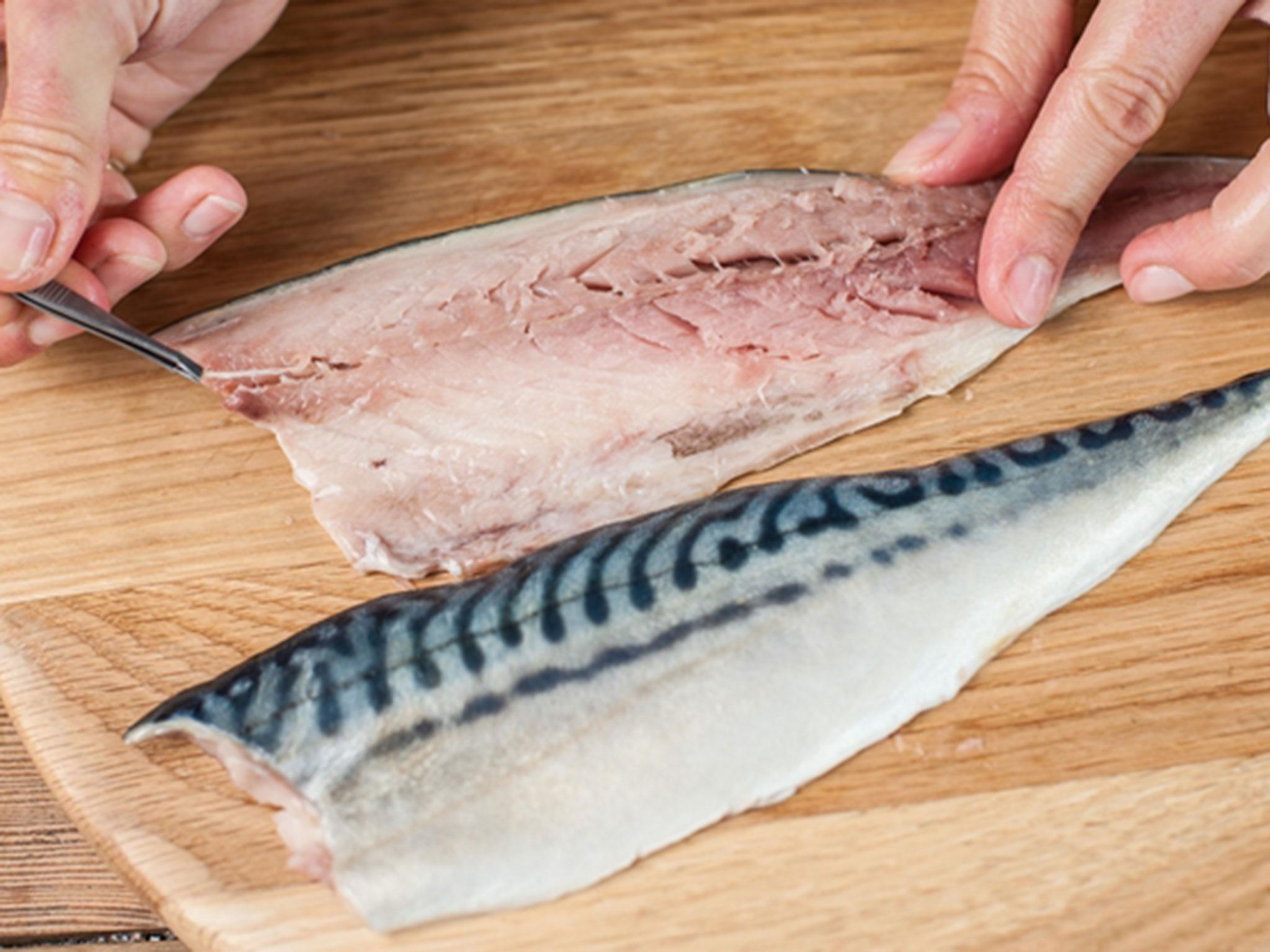 Using tweezers carefully remove the pin-bones from the middle of the fillets