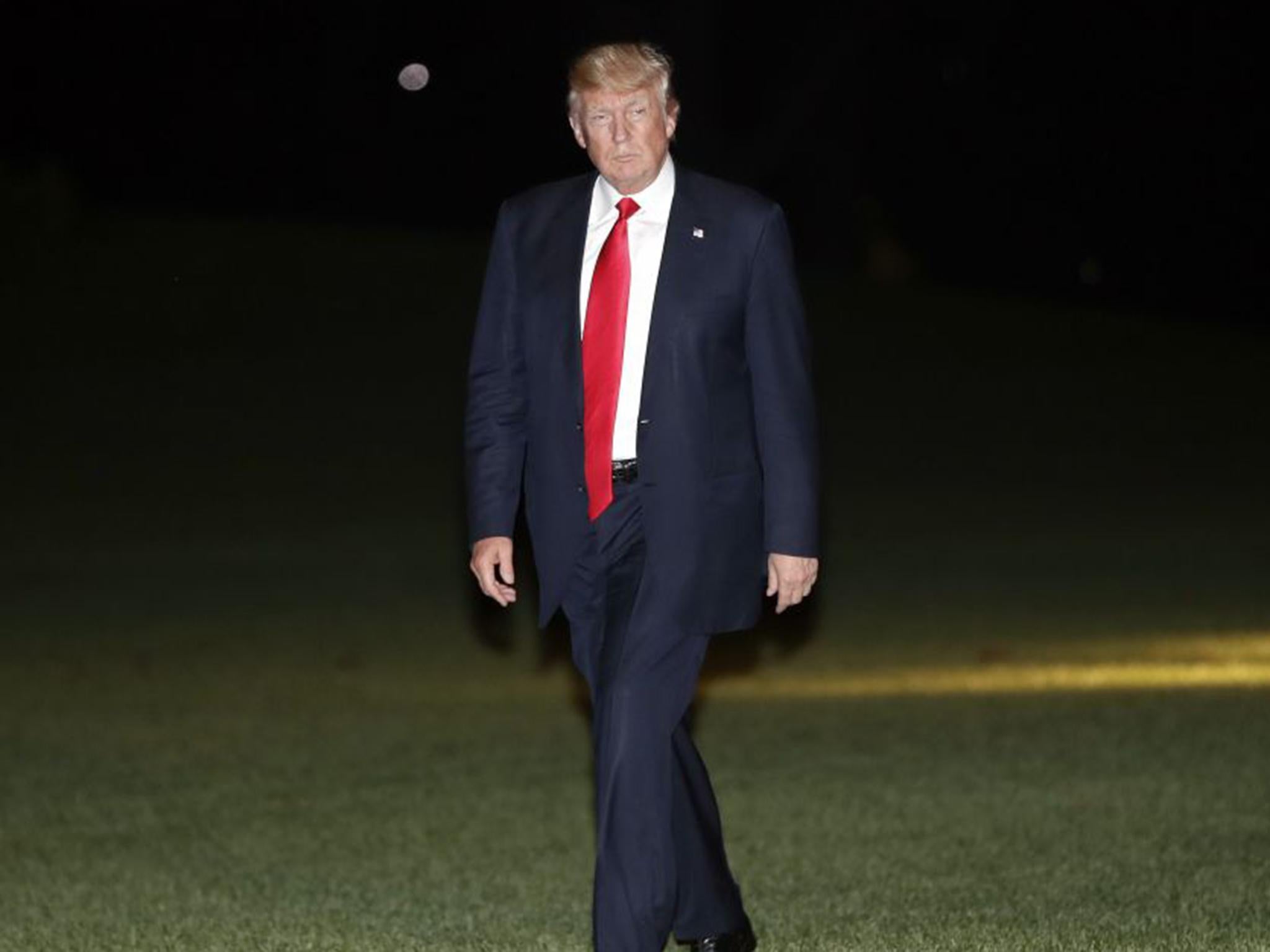 President Donald Trump walks across the South Lawn of the White House