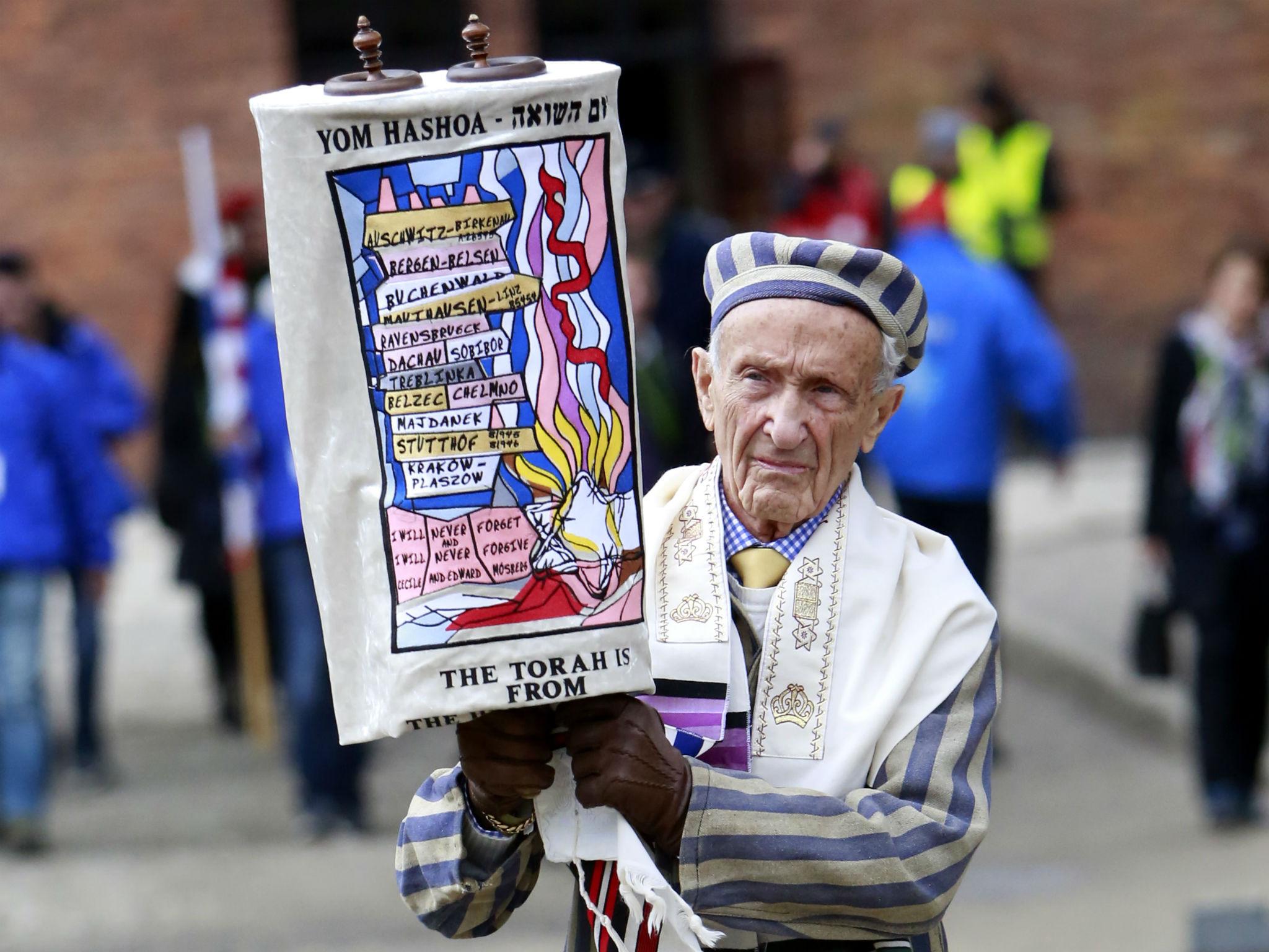 Mosberg carrying the Torah at the 2017 March of the Living between Auschwitz and Birkenau