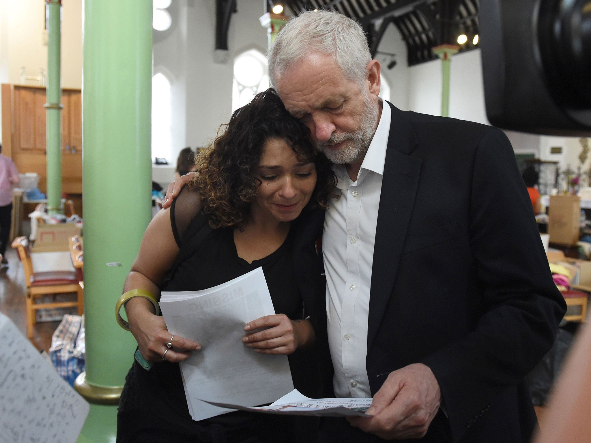 Labour leader Jeremy Corbyn comforts a local resident at St Clement's Church in west London (Getty Images)