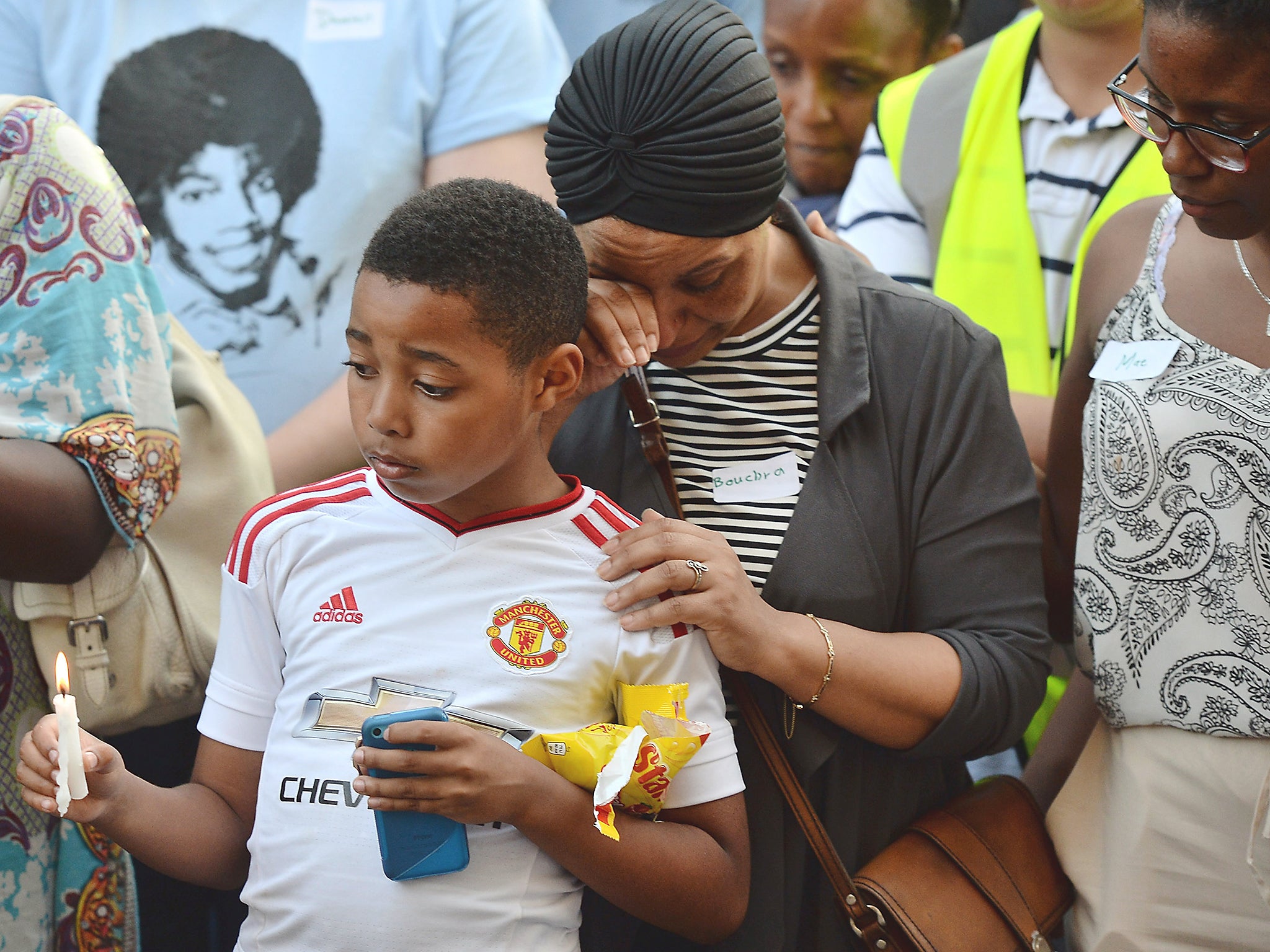 Emotions run high as people attend a candle lit vigil outside Notting Hill Methodist Church near the 24-storey residential Grenfell Tower block (Getty)