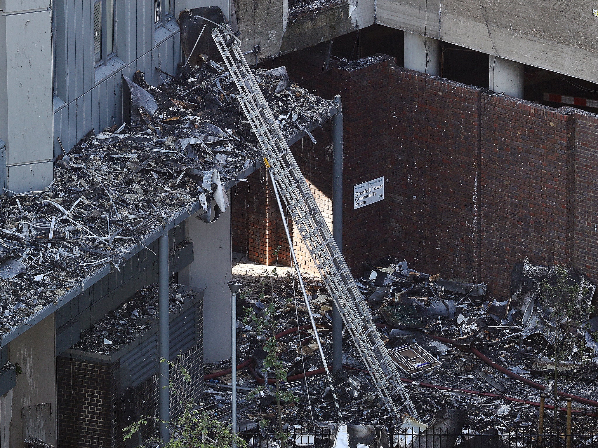 A ladder extends insdie the rubble of Grenfall tower as it continues to smoulder