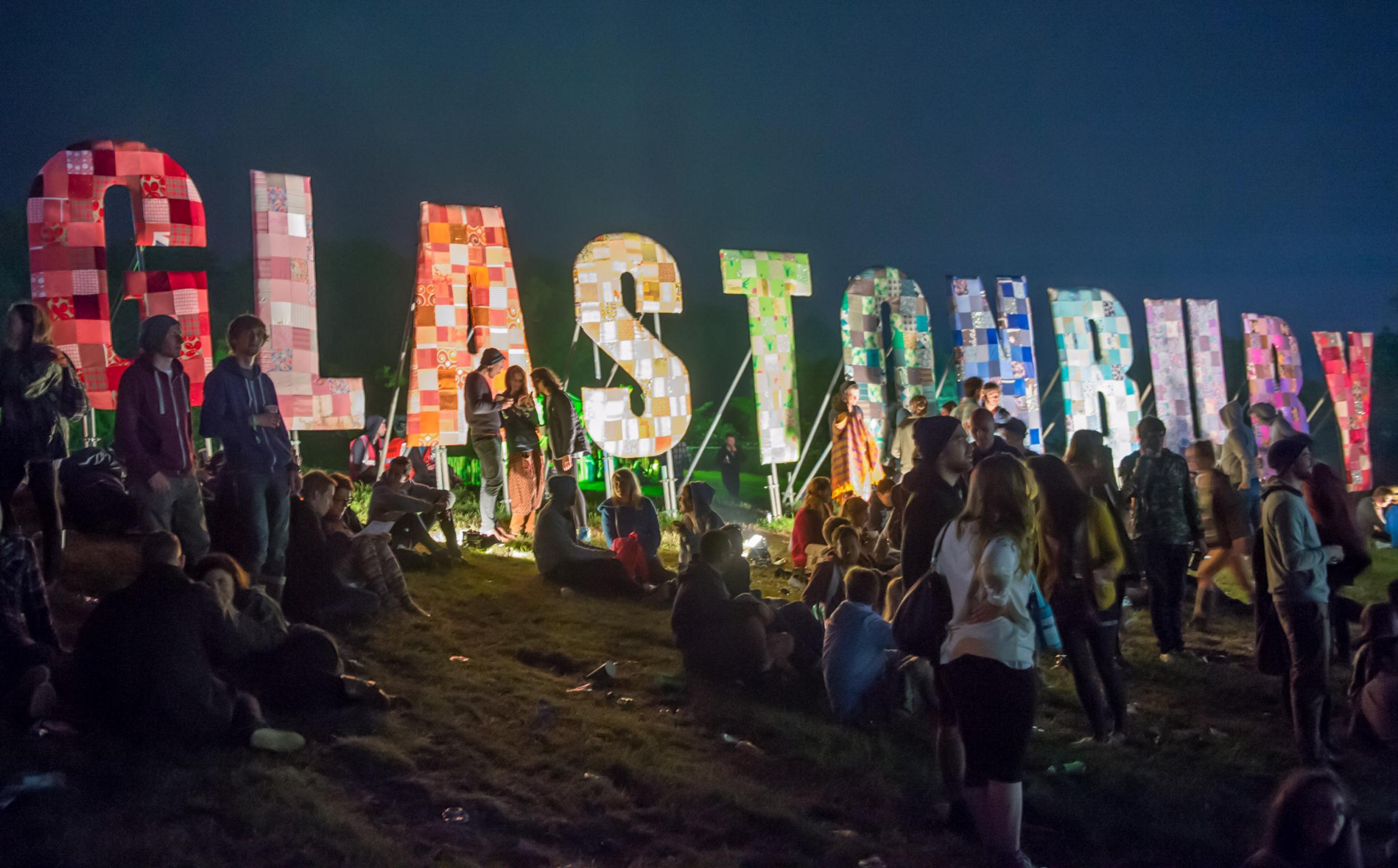 Festival-goers enjoy the atmosphere prior to the 2013 Glastonbury Festival at Worthy Farm on June 26, 2013 in Glastonbury, England