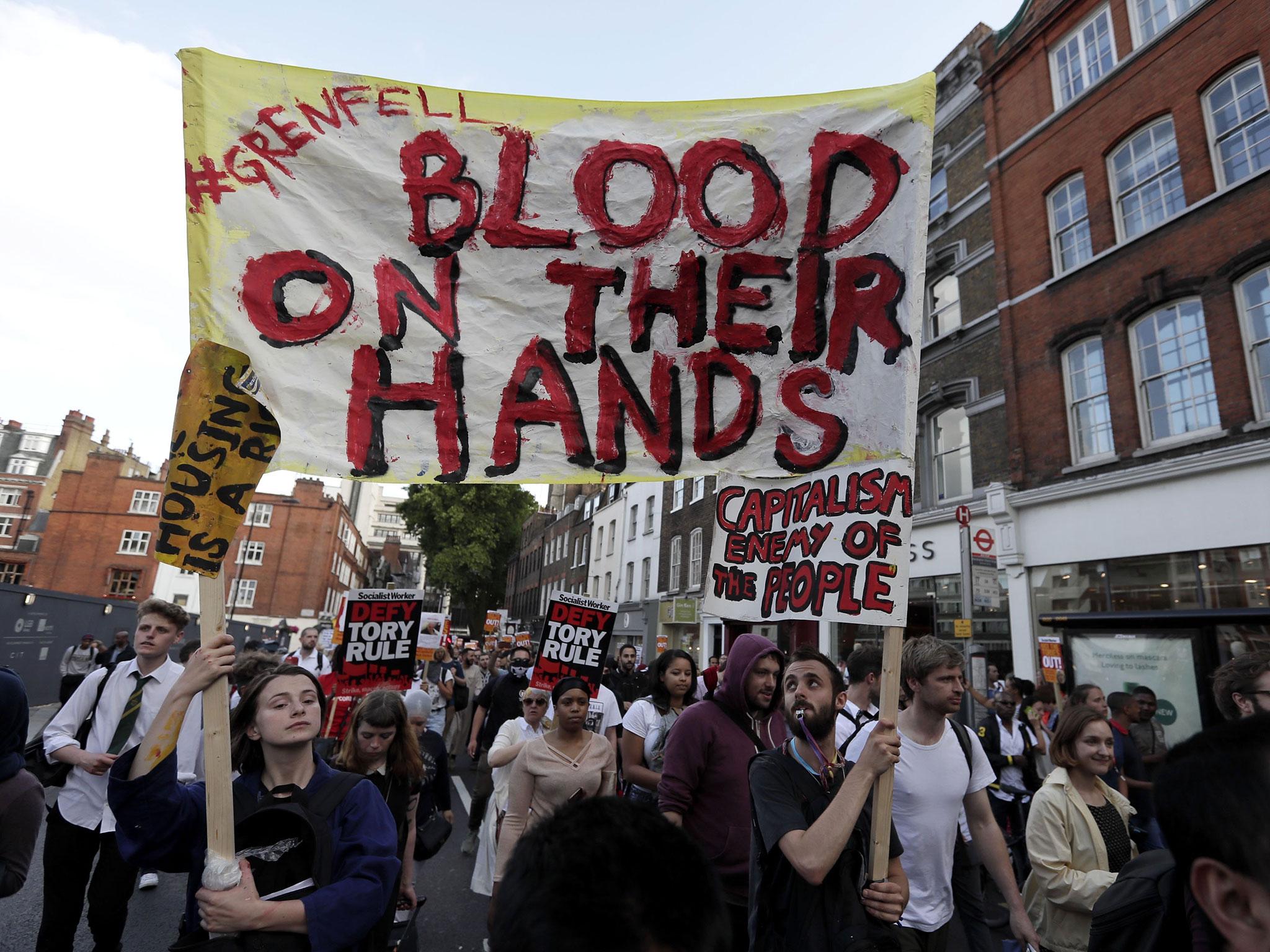 Protesters make their way from Kensington Town Hall to the site of the tower near Notting Hill