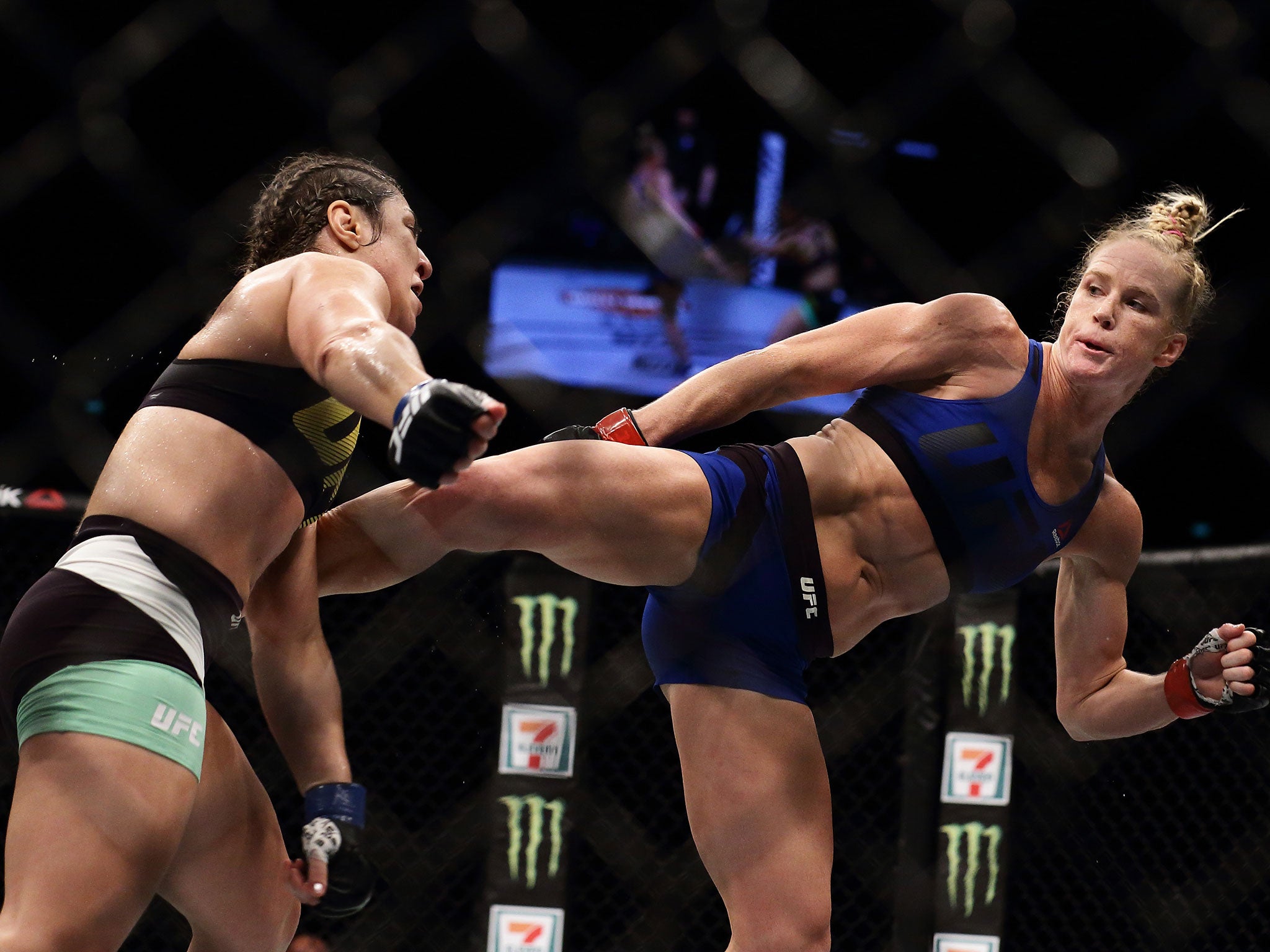 Holly Holm lands a kick against Bethe Correia