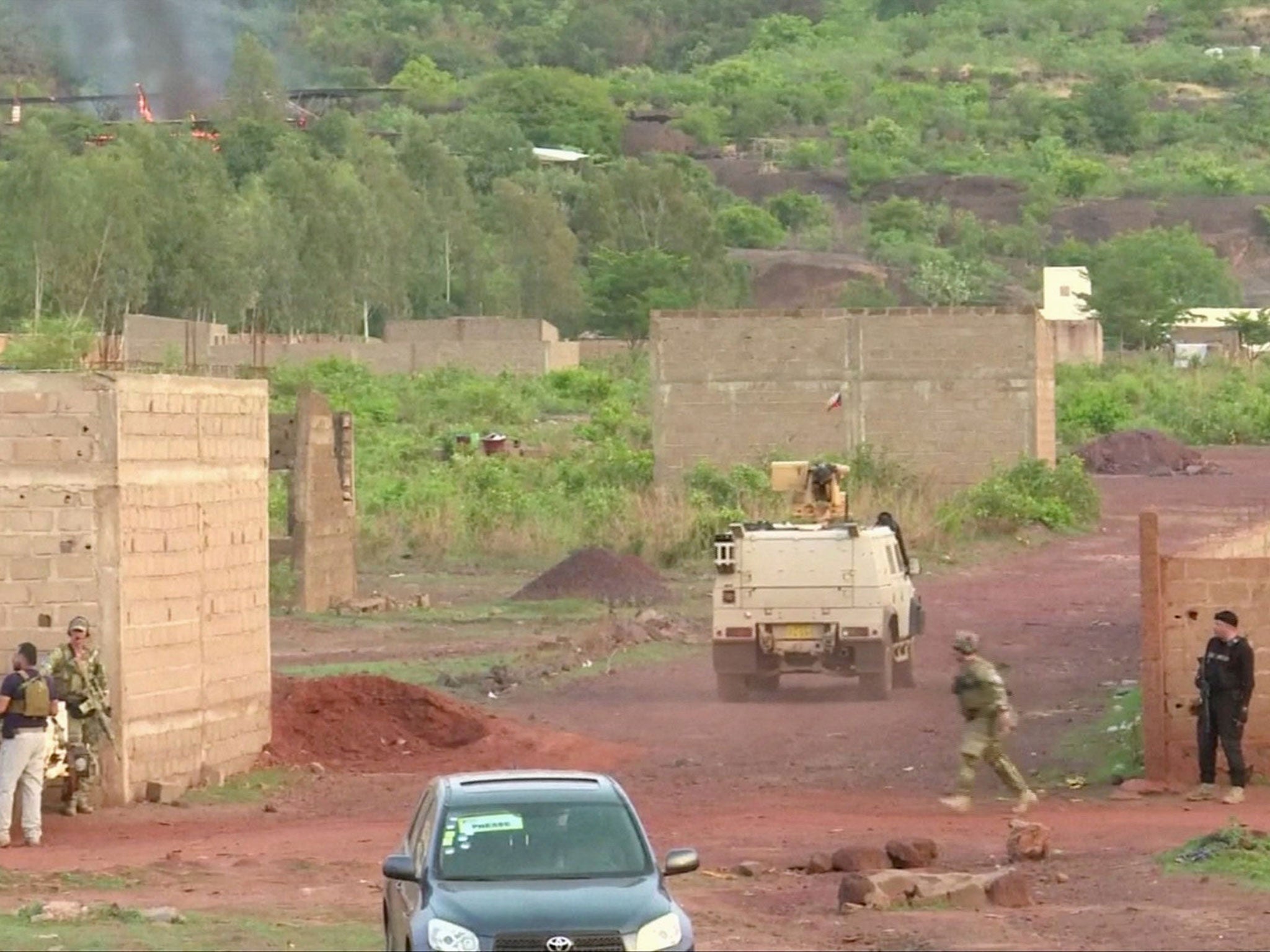 An armoured vehicle drives towards Le Campement following an attack where gunmen stormed the resort in Dougourakoro, to the east of the capital Bamako, Mali