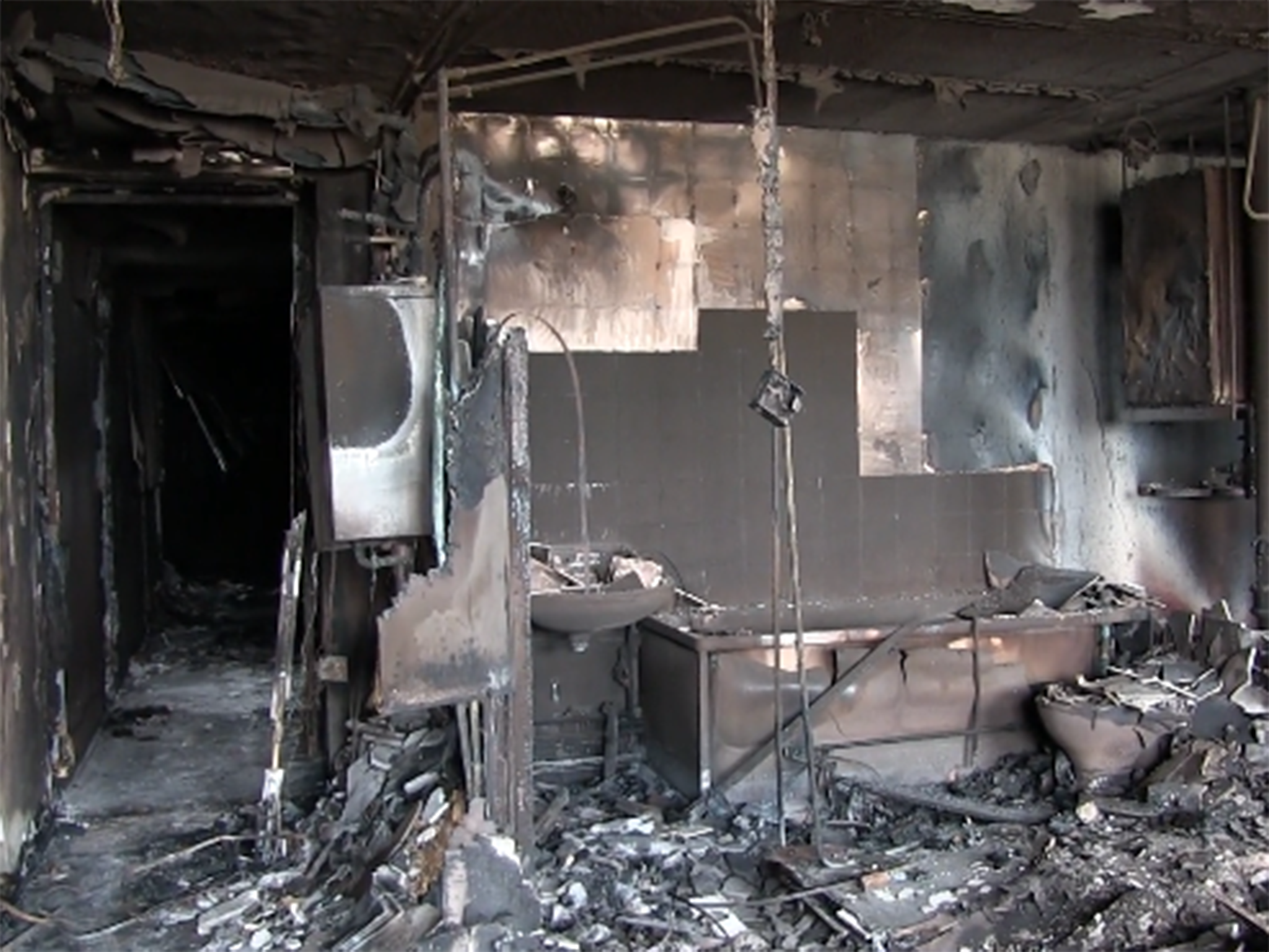 A still from a video shared by police shows the remnants of a burnt-out bathroom