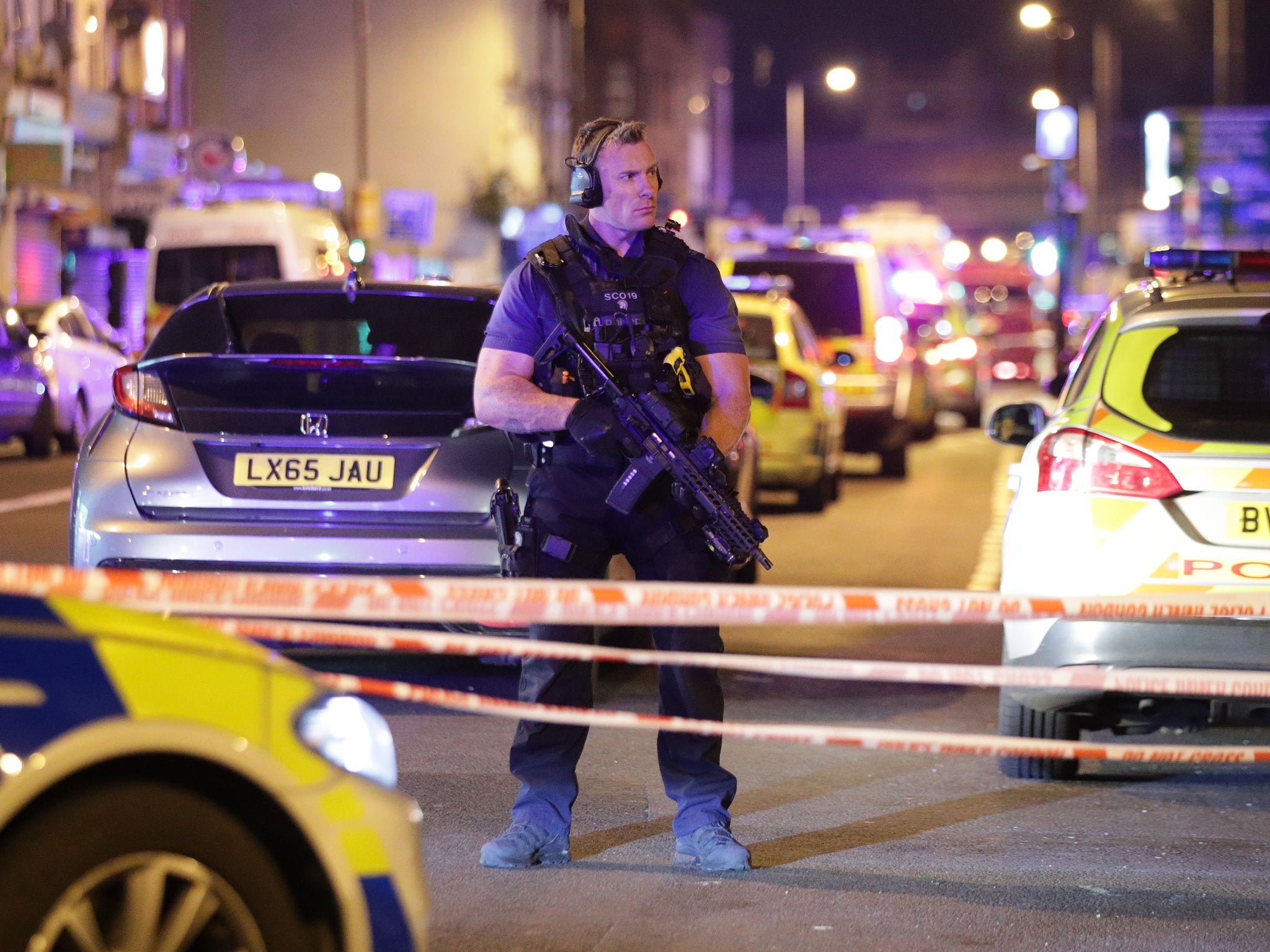 An armed police officer mans a cordon on the Seven Sisters Road at Finsbury Park in north London, where one person has been arrested after a vehicle struck pedestrians (PA Wire/PA Images)