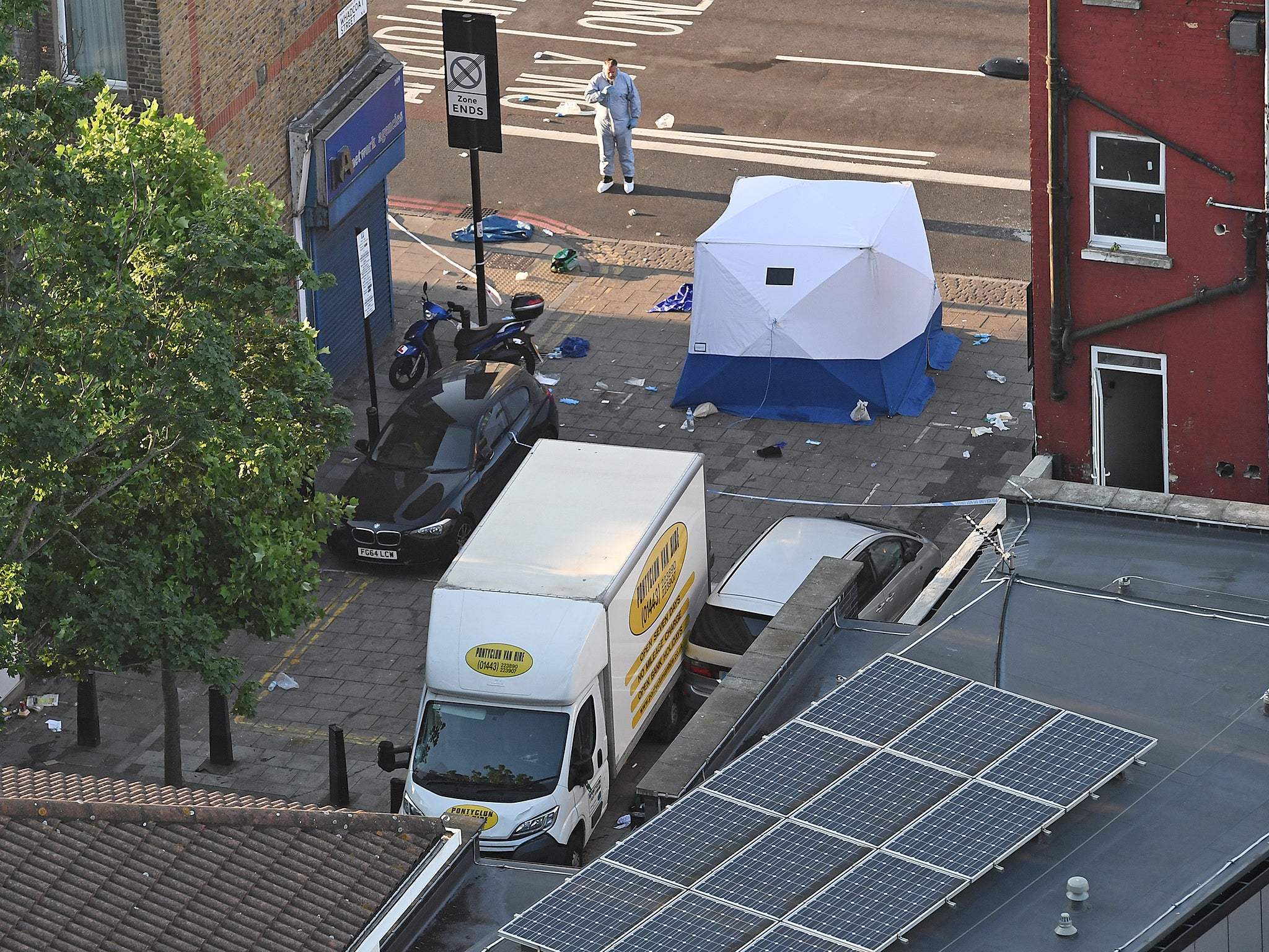 A police forensics officer stands next to a van involved in a terror attack outside Finsbury Park Mosque