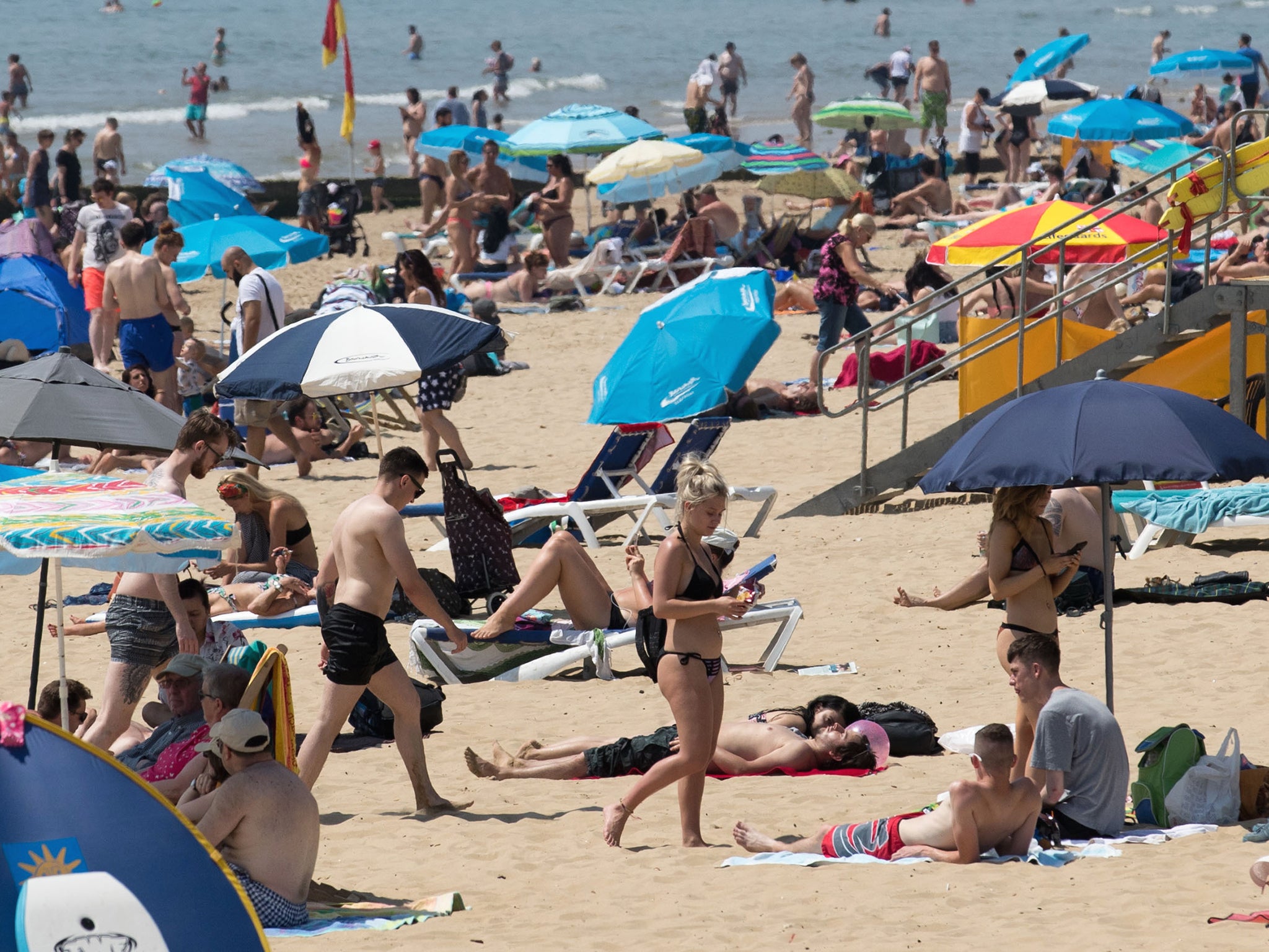 People enjoy the hot weather on the beach in Bournemouth, Dorset, as temperatures are expected to continue to soar this week as the country basks in a heatwave