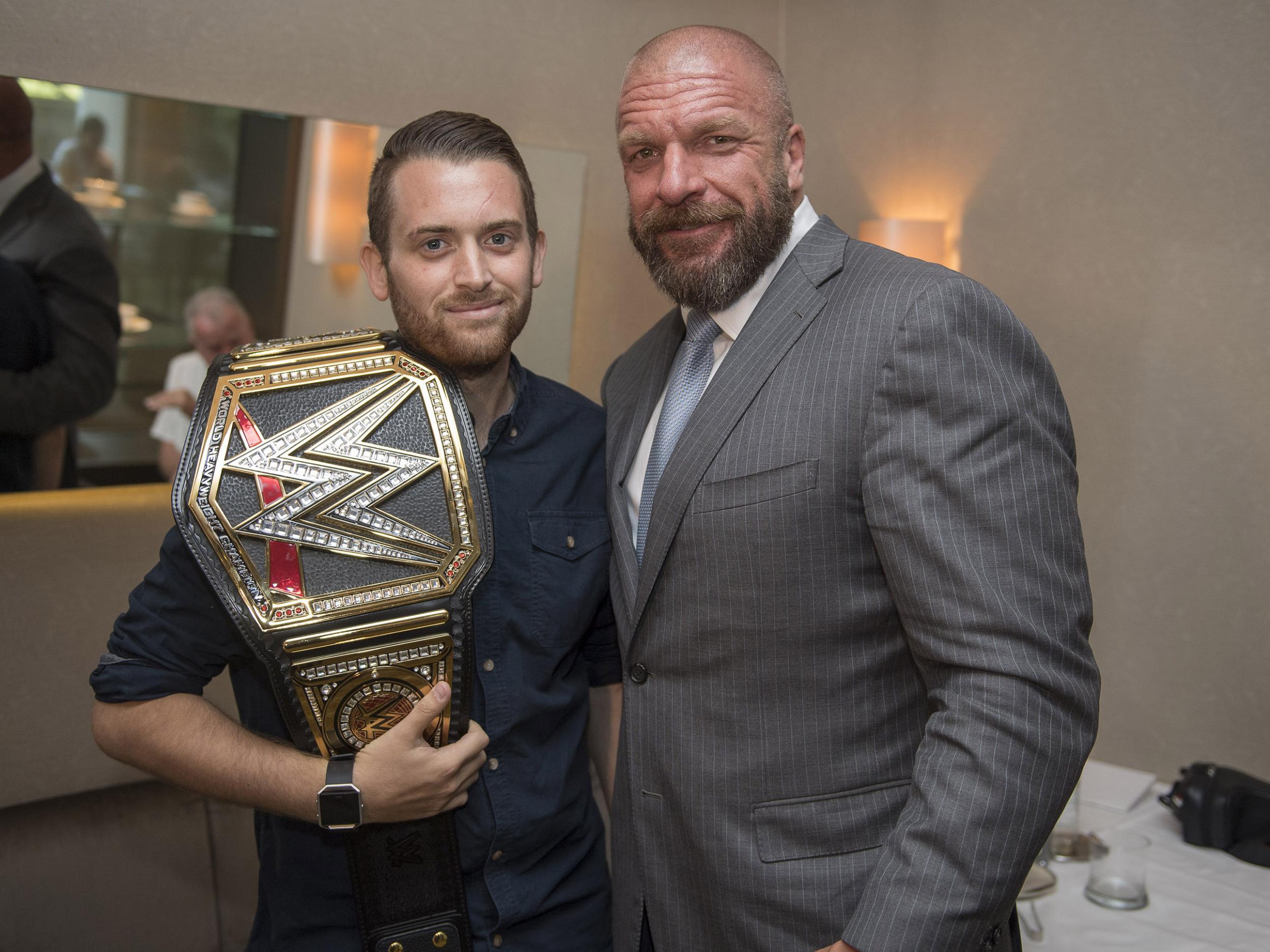 Triple H presented Guenigault with a belt which read: 'To Charlie, thank you to a true hero!'