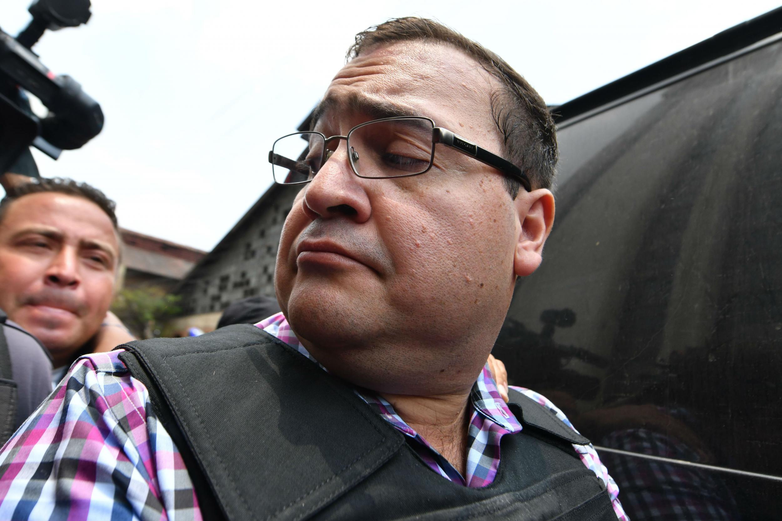 &#13;
Javier Duarte, former governor of the Mexican state of Veracruz, is escorted by police for a hearing at the Supreme Court in Guatemala City in April &#13;