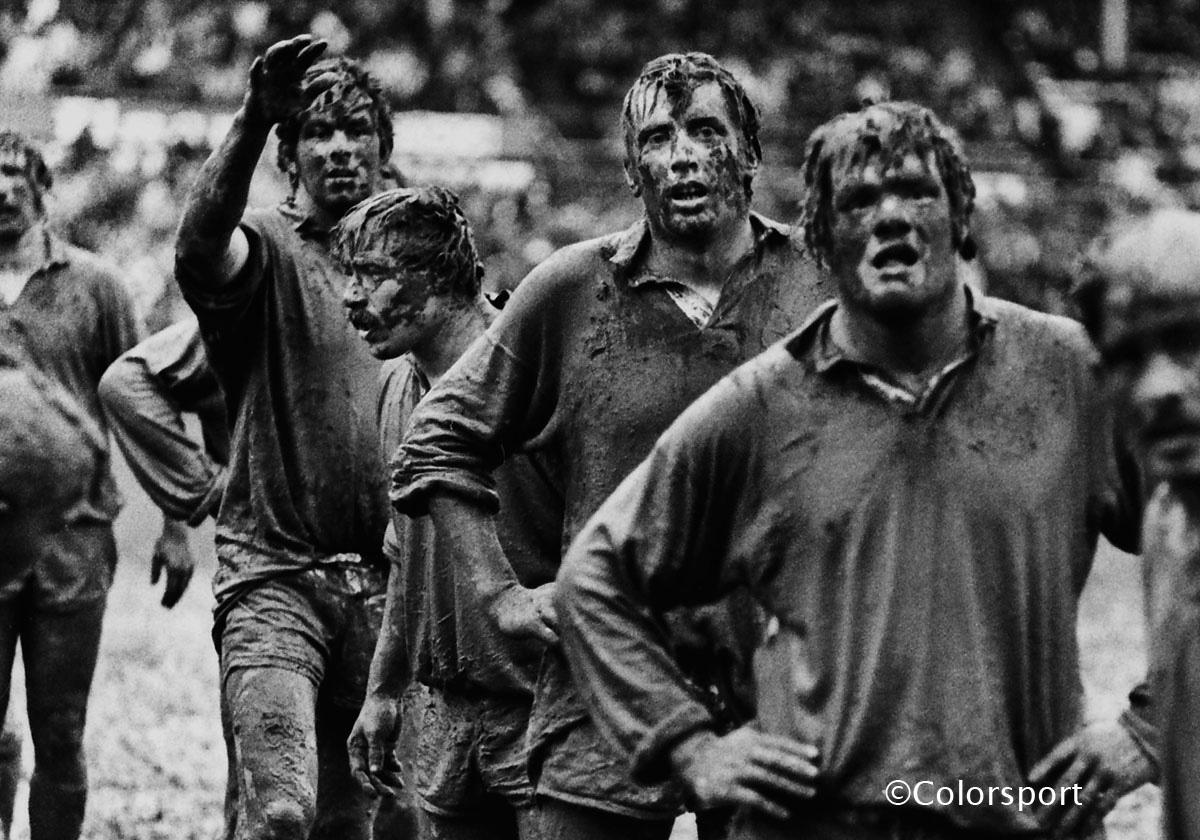 1977 | NZ Jnrs 9 Lions 19 | Mudmen. Lions forwards Allan Martin, Phil Orr, Moss Keane, and Fran Cotton are covered head-to-toe in the Wellington mud as they wait for in a line-out at Athletic Park. The weather would greatly add to the challenge faced by the tourists, with unusually high rainfall for the entirety of the three months invariably falling in the towns where the Lions had their twenty-five games, adding to the siege mentality engendered by the grueling schedule and largely limiting the chances of their quick-fire backs to express their creativity