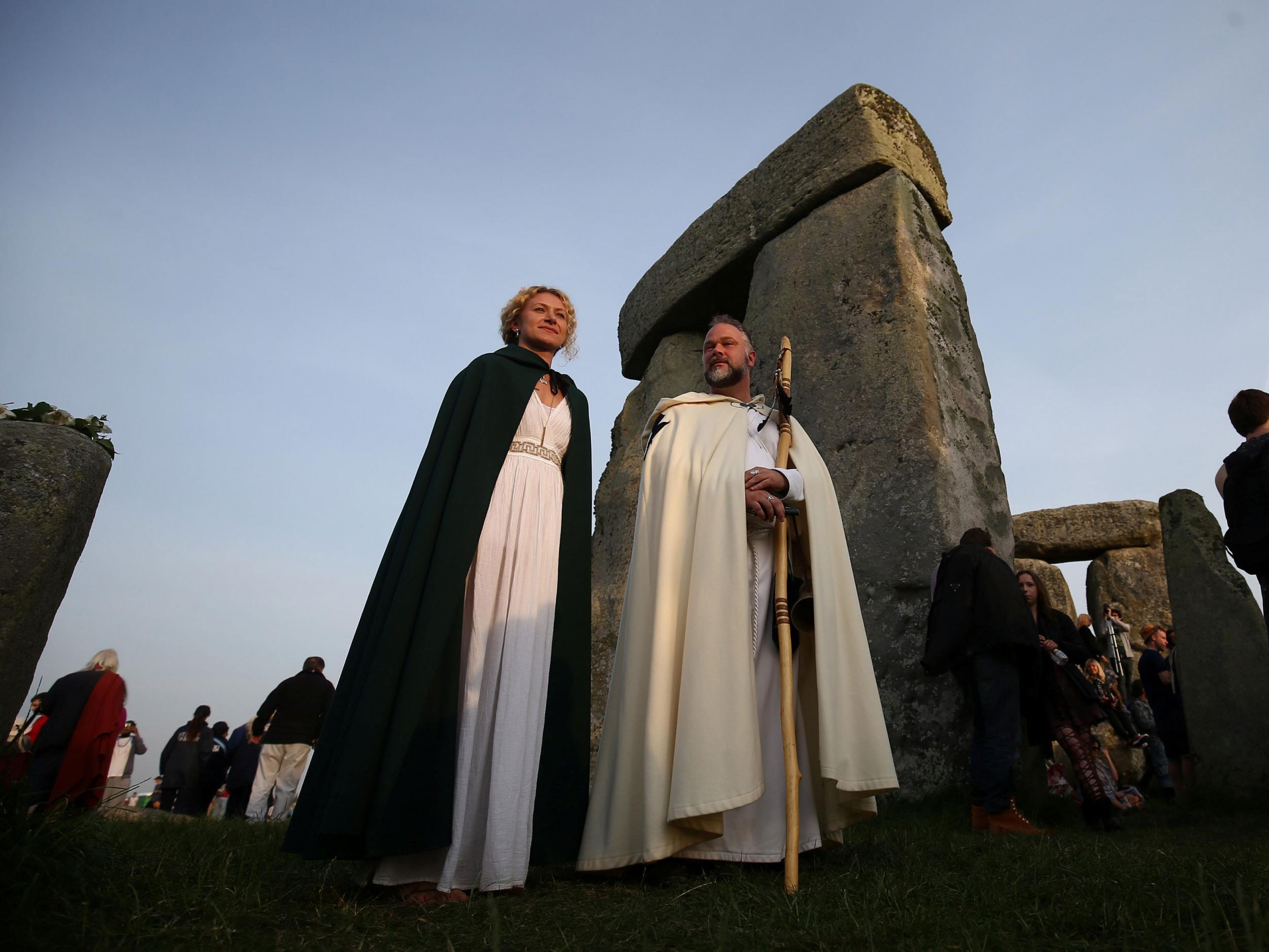 Those clothed in druid costume watch the sun rise on the Stonehenge monument