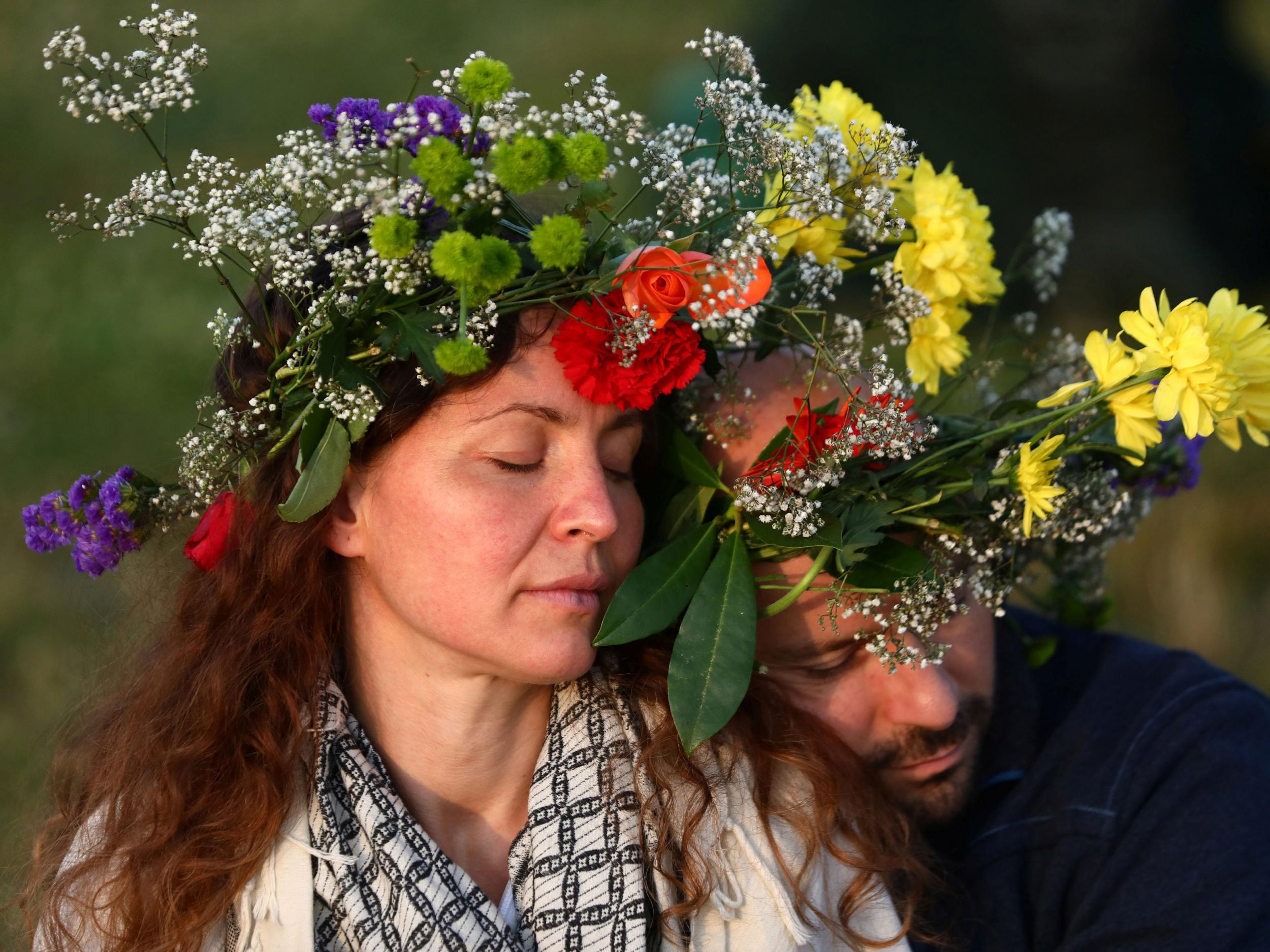 Others wore flower garlands as the sun rose on the late-Neolithic monument