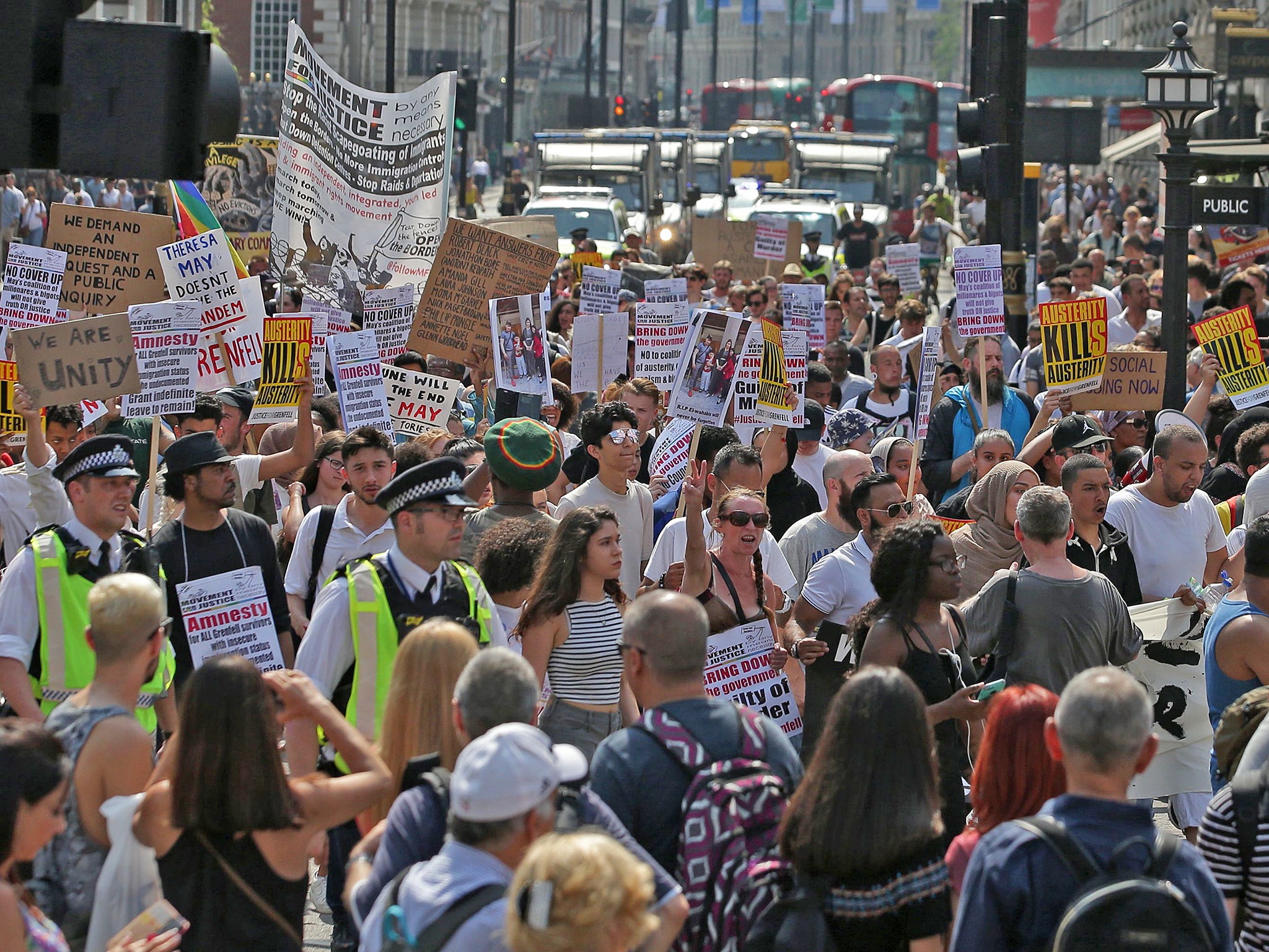 Demonstrators hold up placards as they march through London (AFP/Getty)