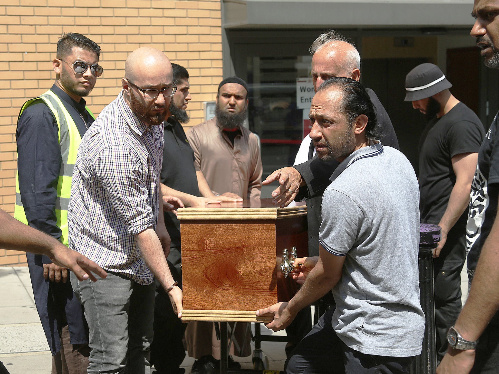 The coffin of Mohammad Alhajali, a victim of the deadly Grenfell Tower blaze, is taken from the east London Mosque in Whitechapel, for his burial.