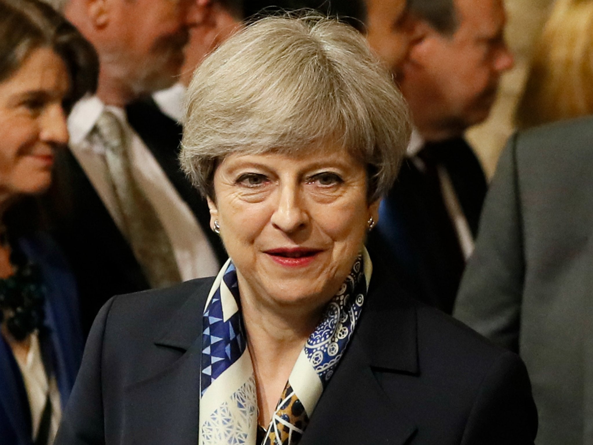 British Prime Minister Theresa May walks through the House of Commons to attend the the State Opening of Parliament