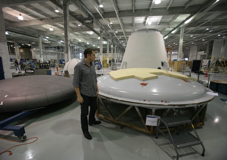 Musk inspecting a heat shield at the SpaceX factory