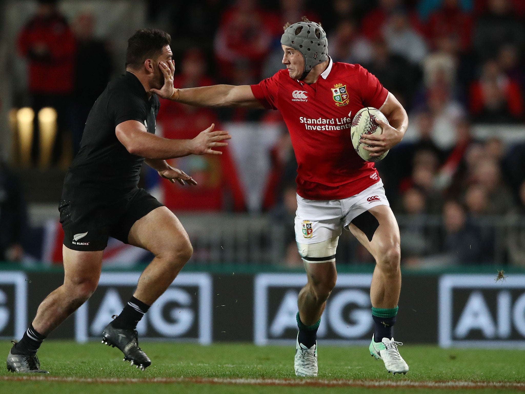 Jonathan Davies hands off Codie Taylor