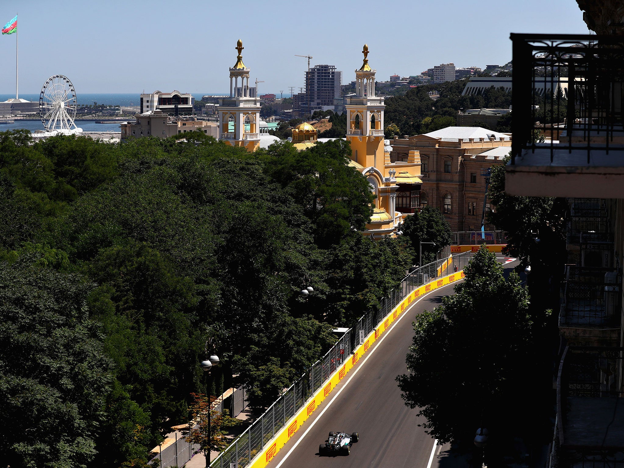 Lewis Hamilton leads the way with the city of Baku in the background