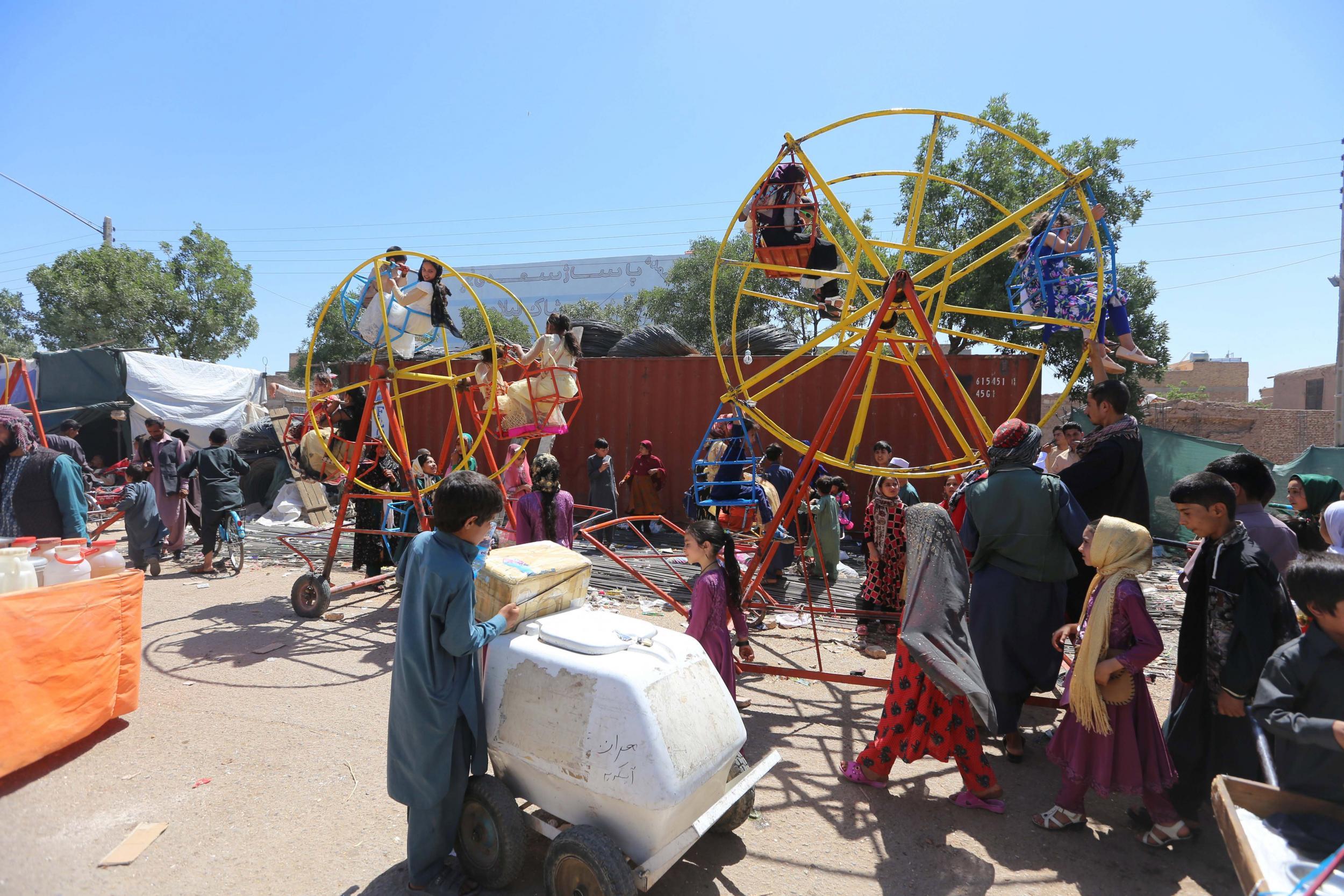 Afghan children ride swings during celebrations in Herat