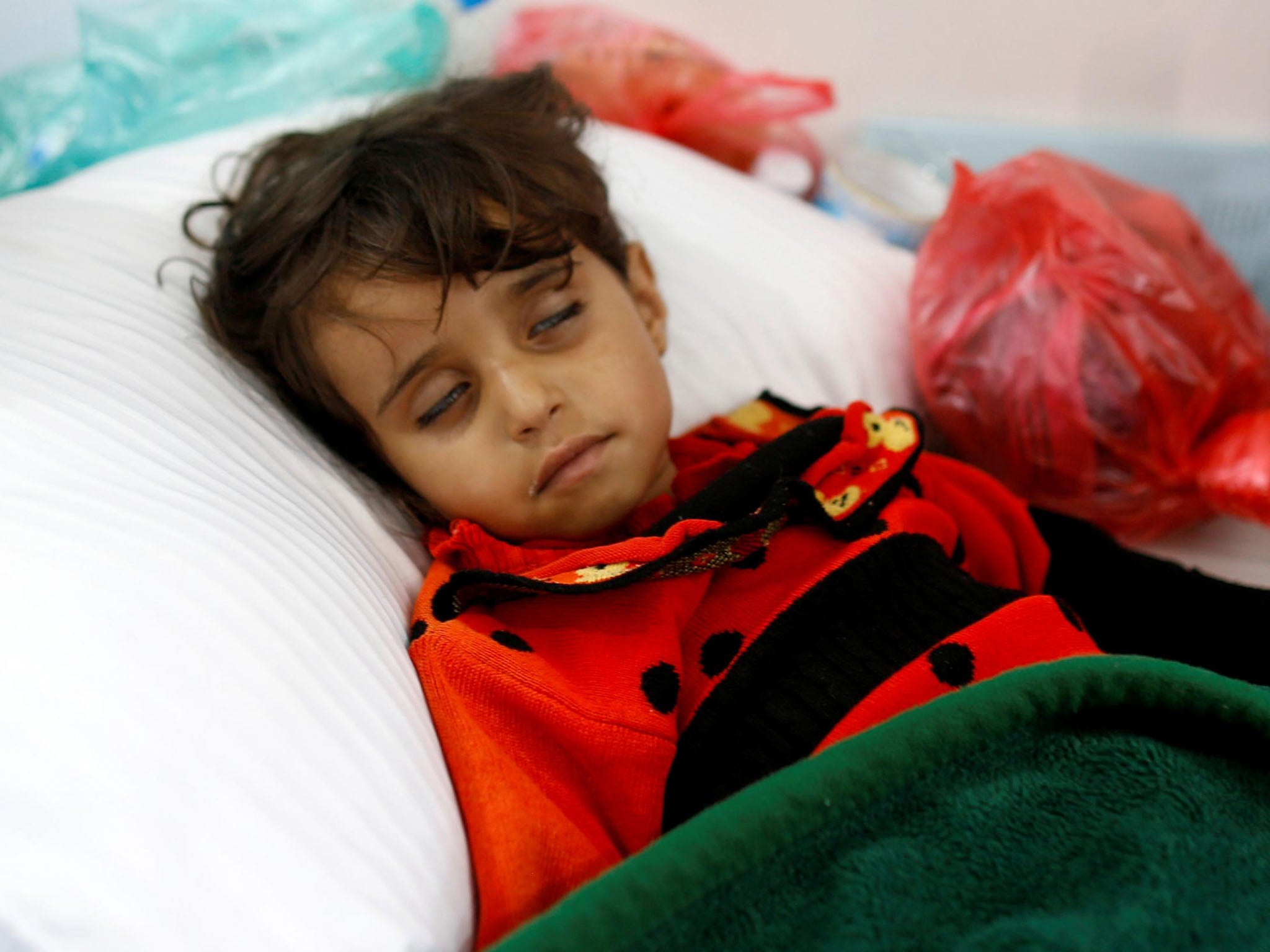 A girl infected with cholera lies on the ground at a hospital in Sanaa, Yemen