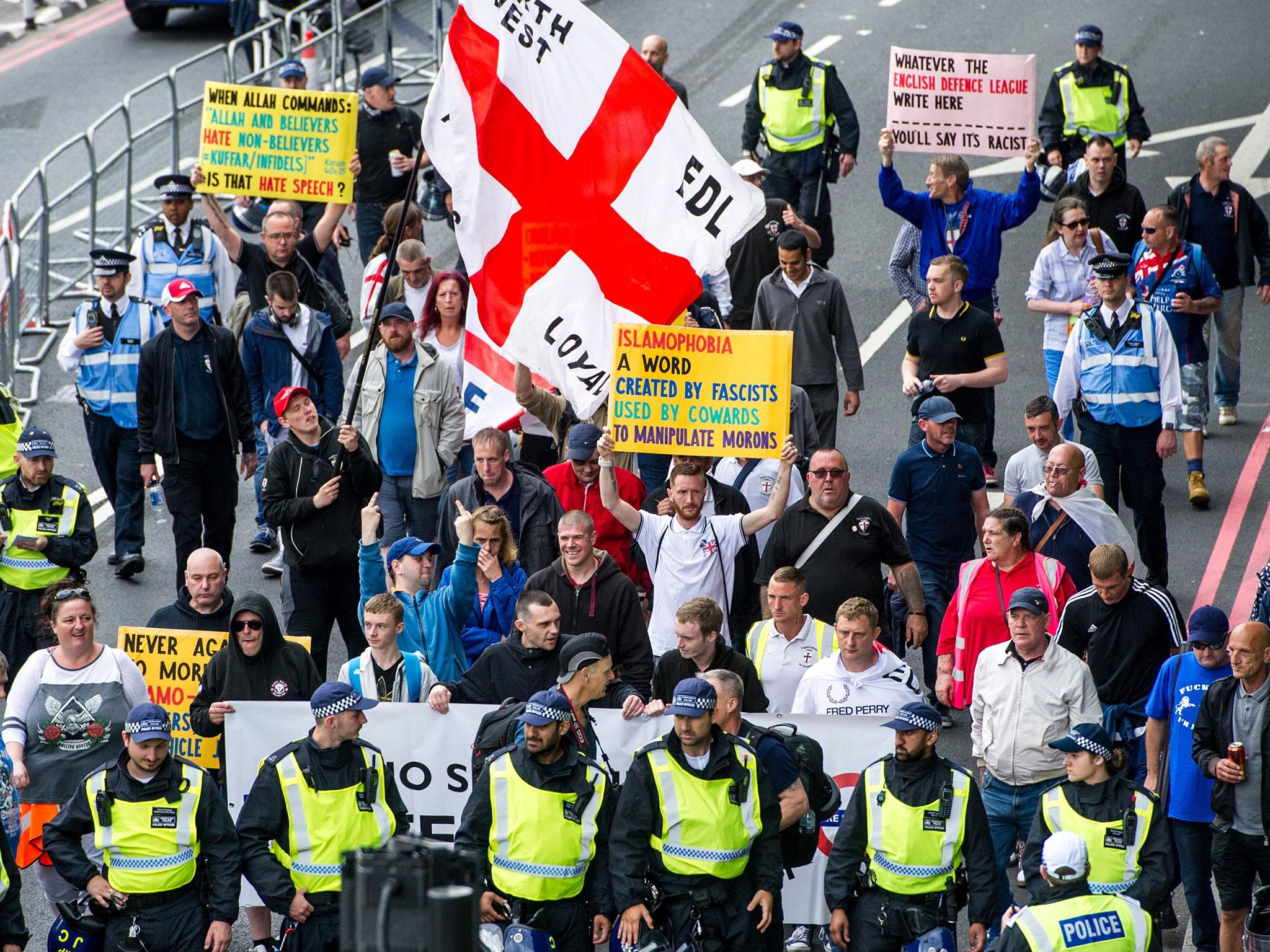 Members of the far-right anti-immigration English Defence League (EDL) march from Victoria Embankment to Charing Cross Station under heavy police guard, in Londnon, as anti-Fascist groups held a counter-demonstration nearby