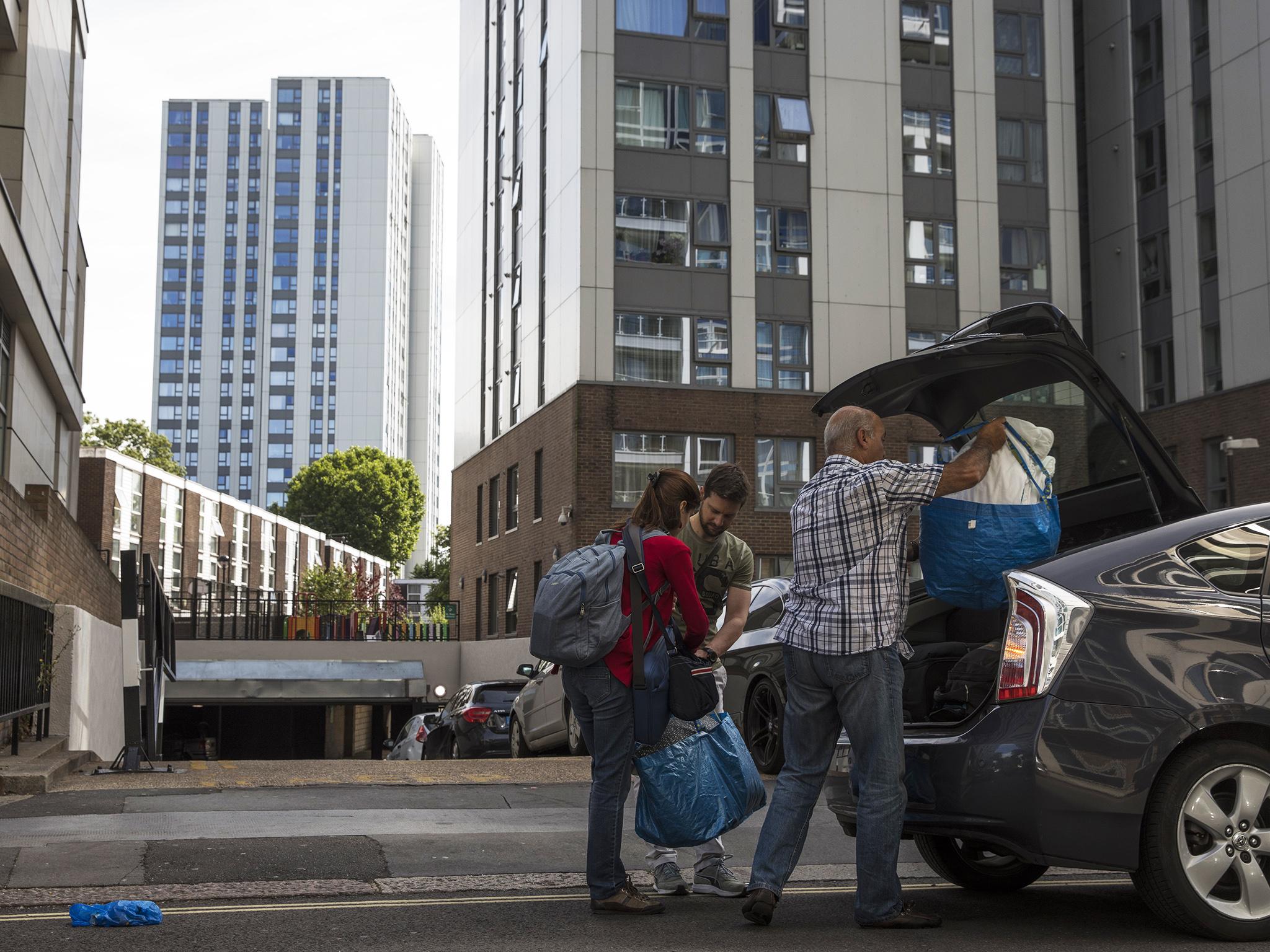 People pack their belongings after evacuating high rise building