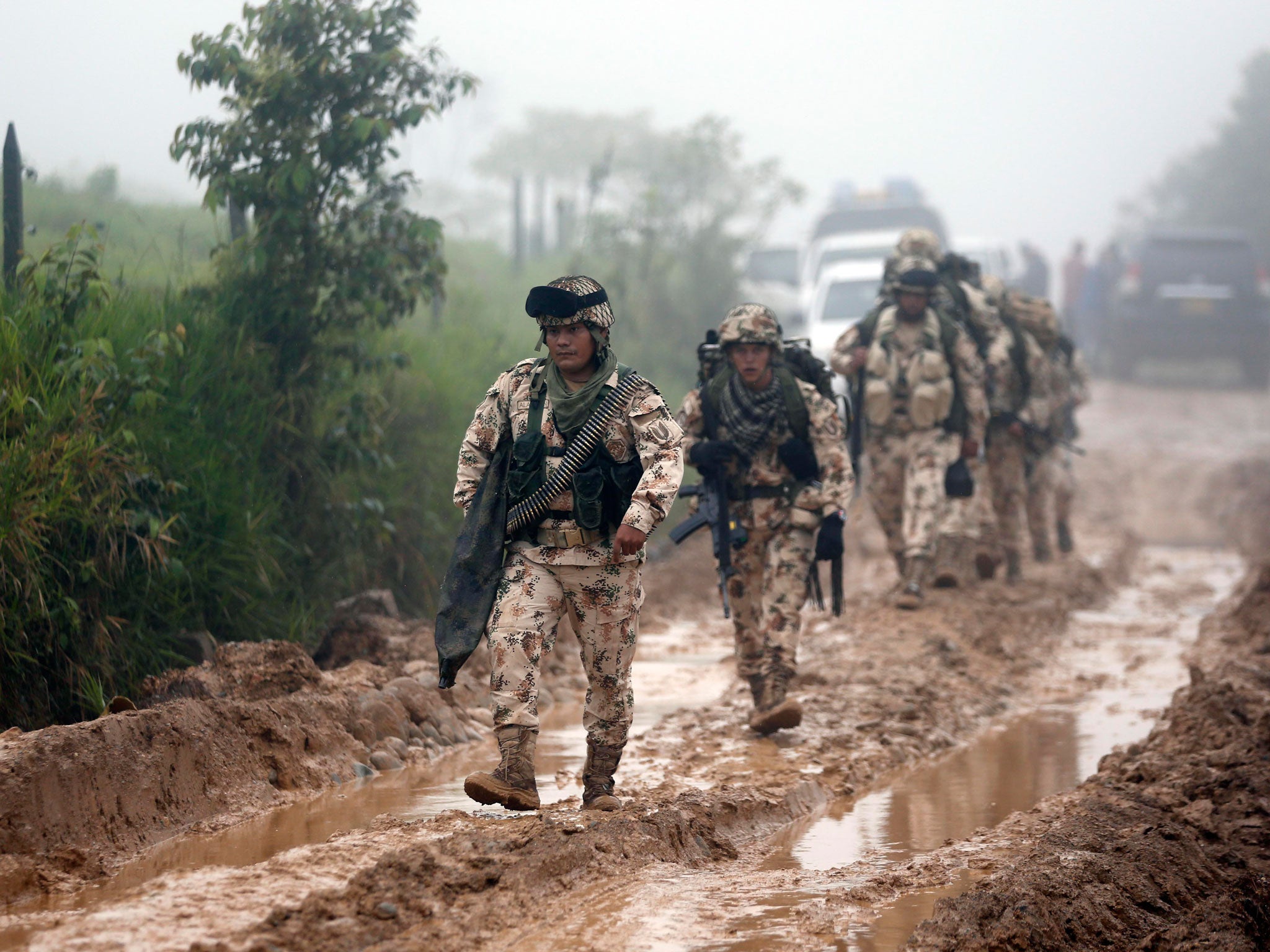 Army soldiers arrive to guard the Mariana Paez demobilization zone, one of many rural camps where FARC rebel fighters are making their transition to civilian life