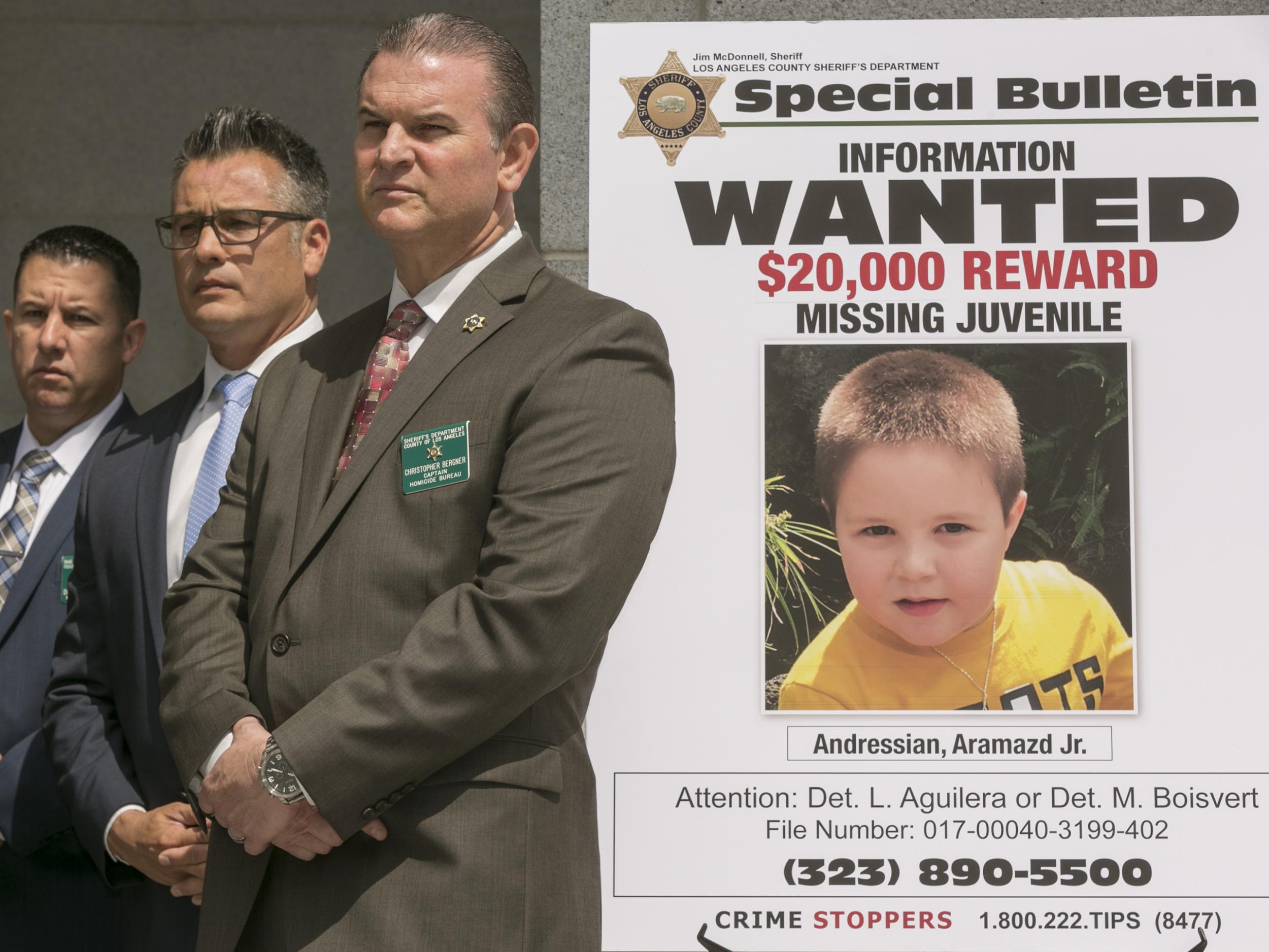 Los Angeles County Sheriff's Department Homicide Bureau Captain Christopher Bergner, centre, stands by a poster of Aramazd Andressian Jr, a five-year-old boy who has been missing for several weeks from South Pasadena