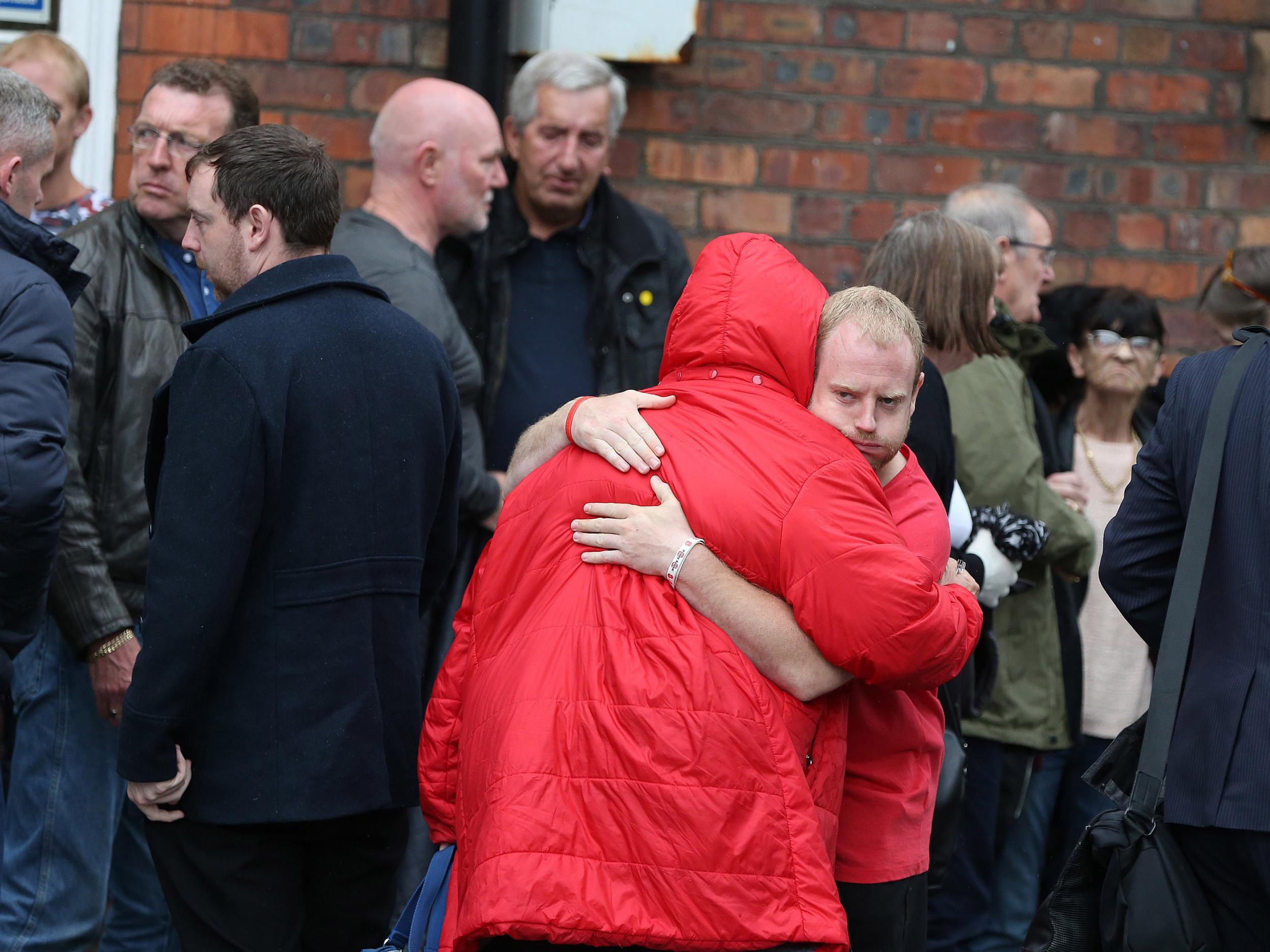 Family members of the 96 Hillsborough victims console each other after learning of the charges laid against six people in relation to the 1989 incident