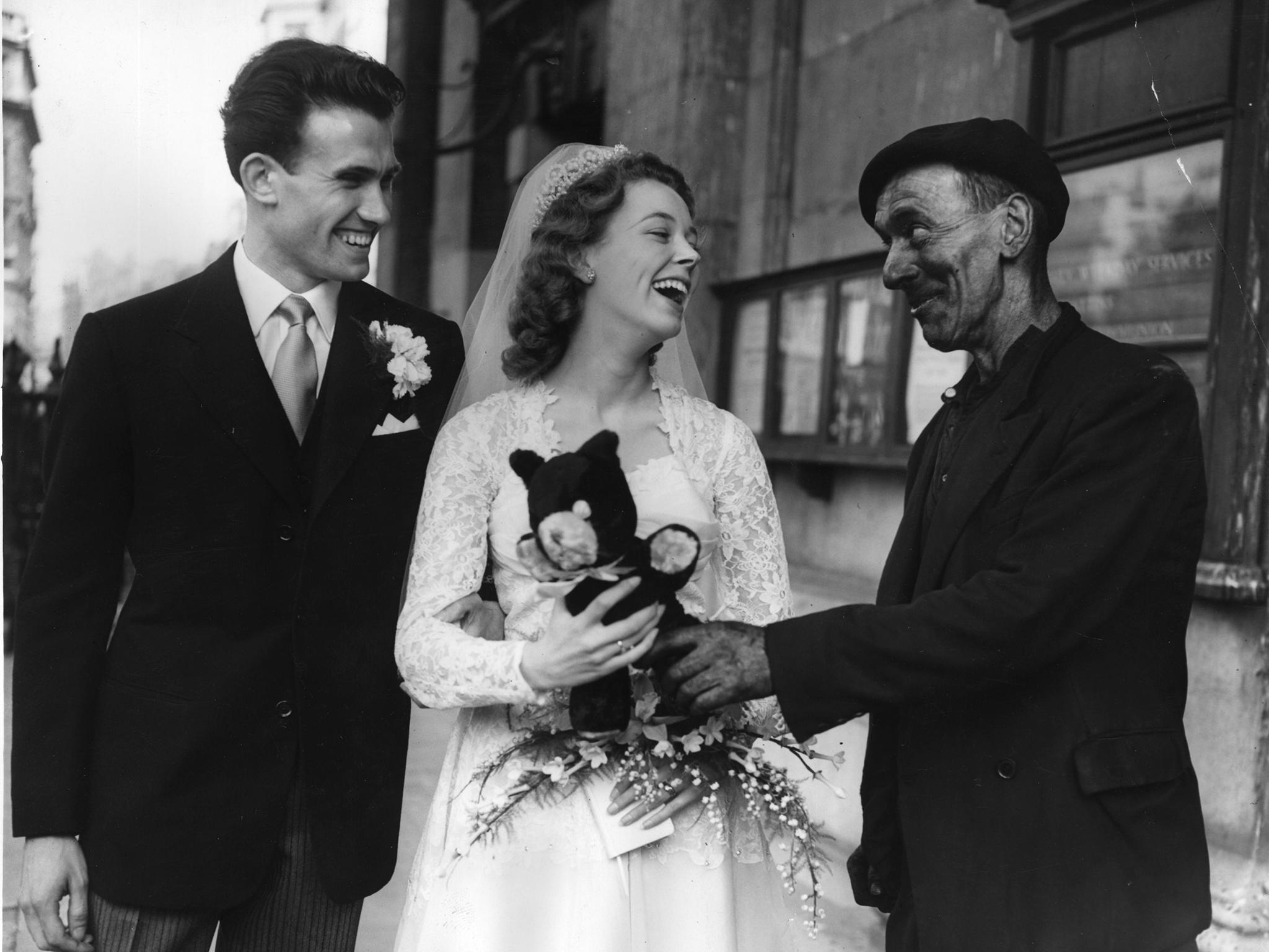 A chimney sweep wishes a couple congratulations in London in 1956