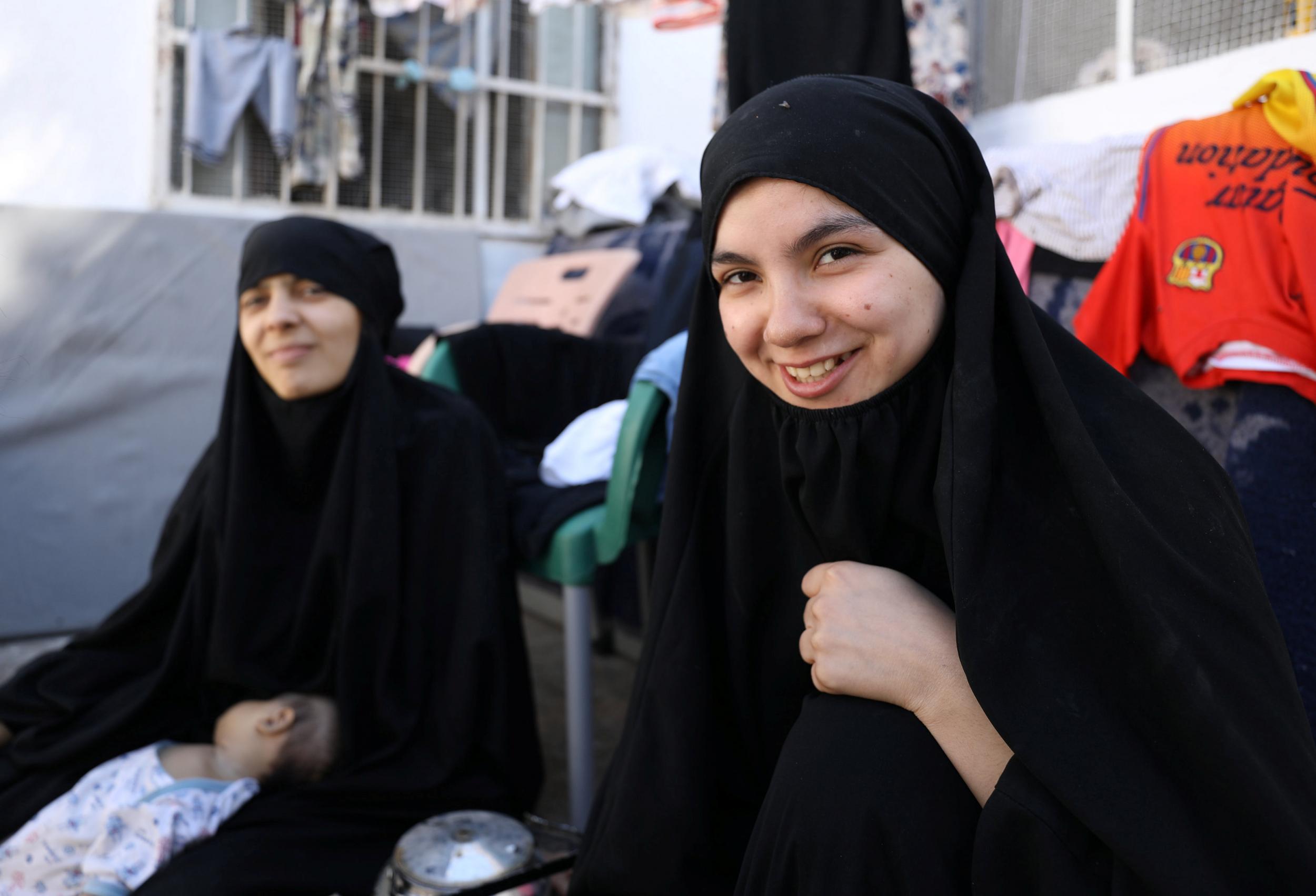 Wives of former Isis fighters Nour al-Huda, who is Lebanese, and Iman Othman, who is Tunisian, wait at a camp for displaced people north of Raqqa