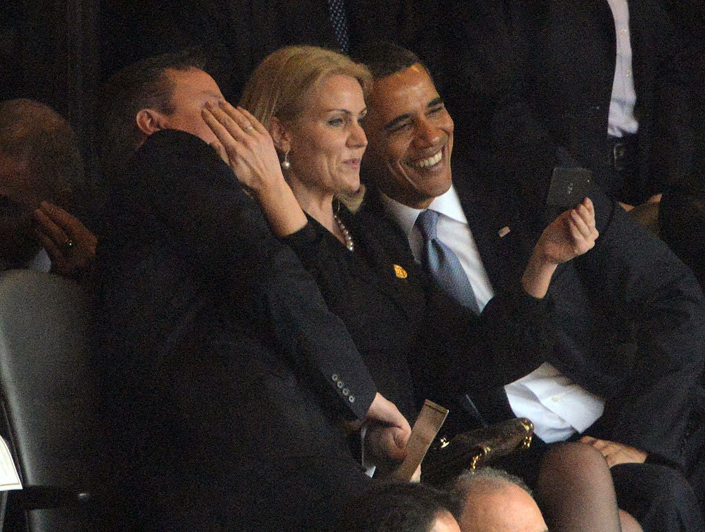 Then-US President Barack Obama (R) and British Prime Minister David Cameron pose for a selfie picture with Denmark’s Prime Minister Helle Thorning Schmidt (C)